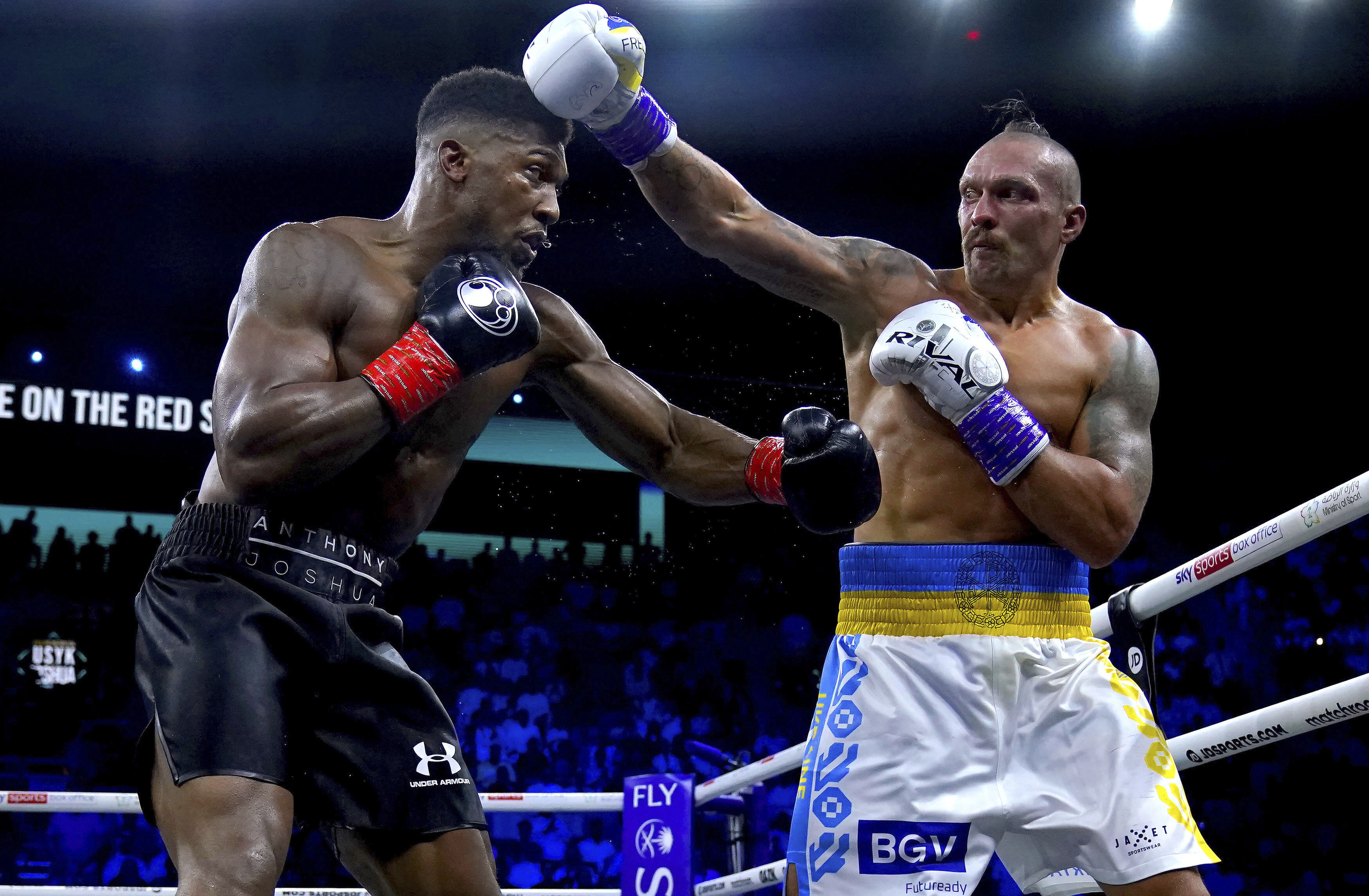 Britain’s Anthony Joshua and Ukraine’s Oleksandr Usyk exchange punches during their world heavyweight title fight at King Abdullah Sports City in Jeddah, Saudi Arabia, Sunday, Aug. 21, 2022. 
