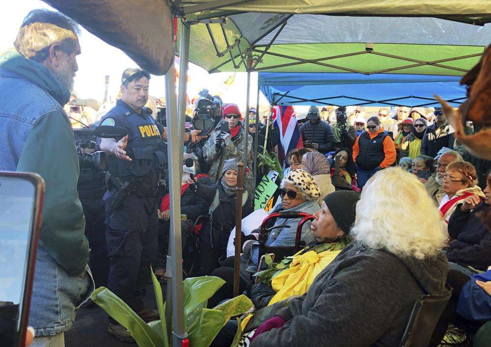 Hawaii Department of Land and Natural Resources prepare to arrest protesters who are blocking a road to prevent construction of a giant telescope on a mountain that some Native Hawaiians consider sacred, on Mauna Kea on the Big Island of Hawaii on July 17, 2019.