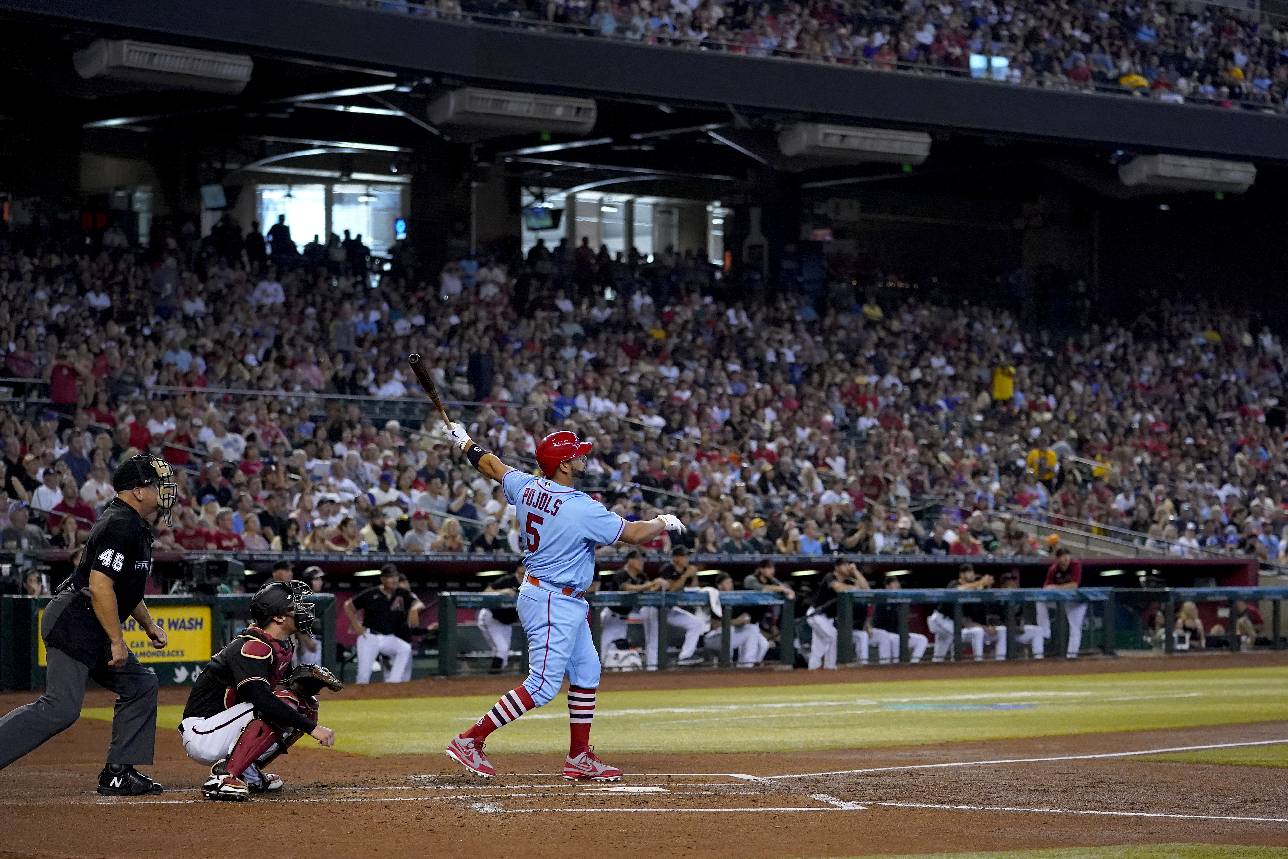 St. Louis Cardinals' Albert Pujols watches his solo home run take flight against the Arizona Diamondbacks during the second inning of a baseball game, Saturday, Aug. 20, 2022, in Phoenix. 