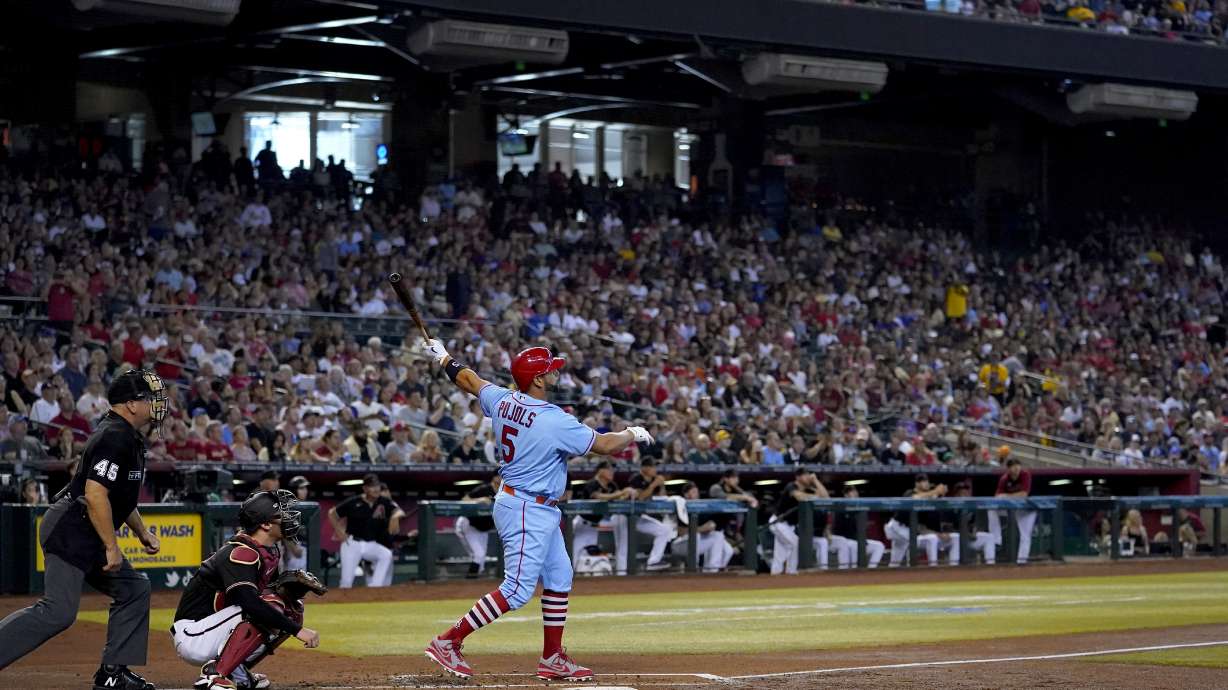 St. Louis Cardinals' Albert Pujols watches his solo home run take flight against the Arizona Diamondbacks during the second inning of a baseball game, Saturday, Aug. 20, 2022, in Phoenix.