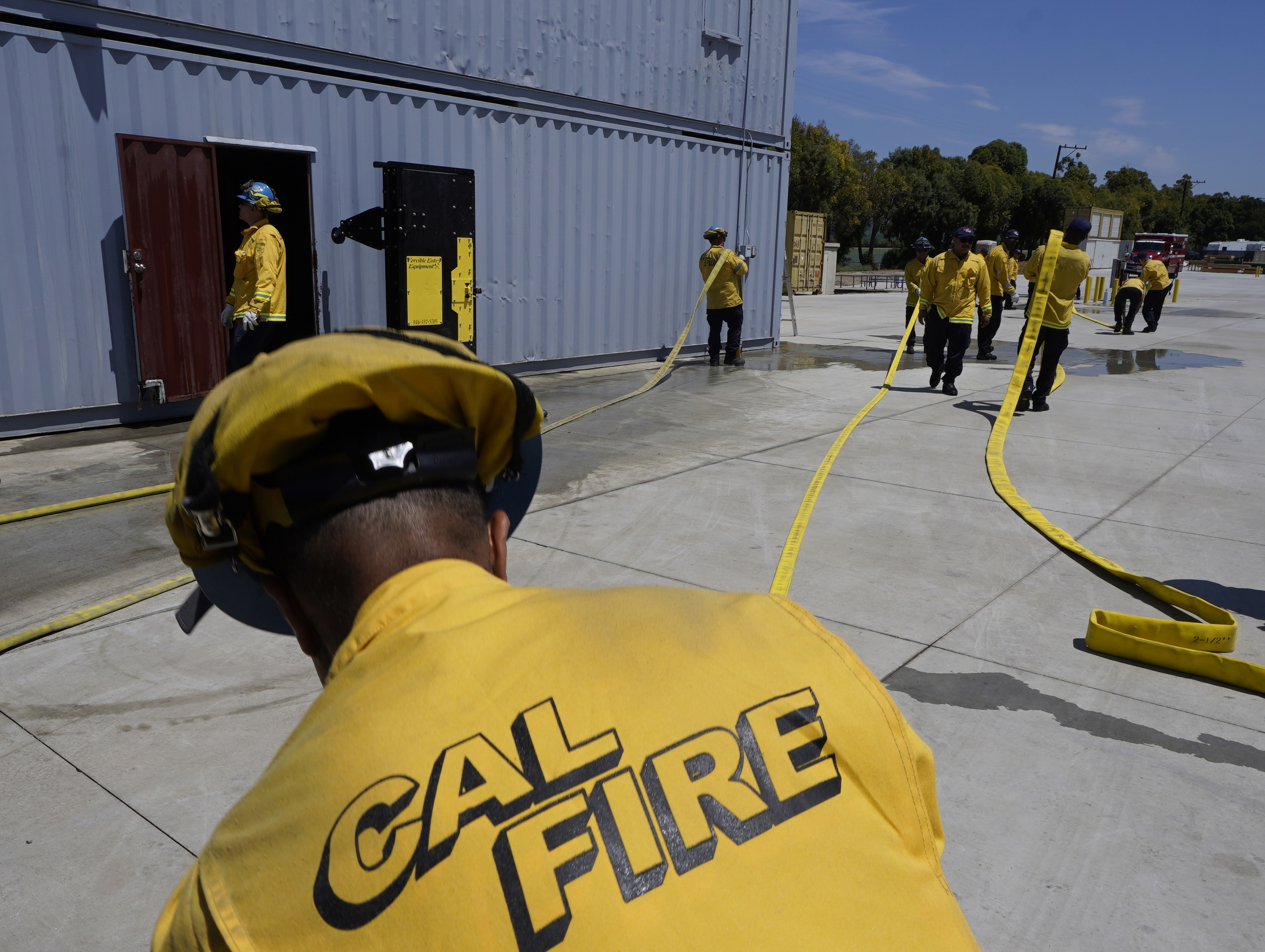 Cadets, who were formerly-incarcerated firefighters, train at the Ventura Training Center (VTC) during an open house media demonstration on Thursday, July 14, 2022, in Camarillo, Calif. California has a first-in-the nation law and a $30 million training program both aimed at trying to help former inmate firefighters turn pro after they are released from prison. The 18-month program is run by Cal Fire, the California Conservation Corps, the state corrections department and the nonprofit Anti-Recidivism Coalition at the Ventura Training Center northwest of Los Angeles.