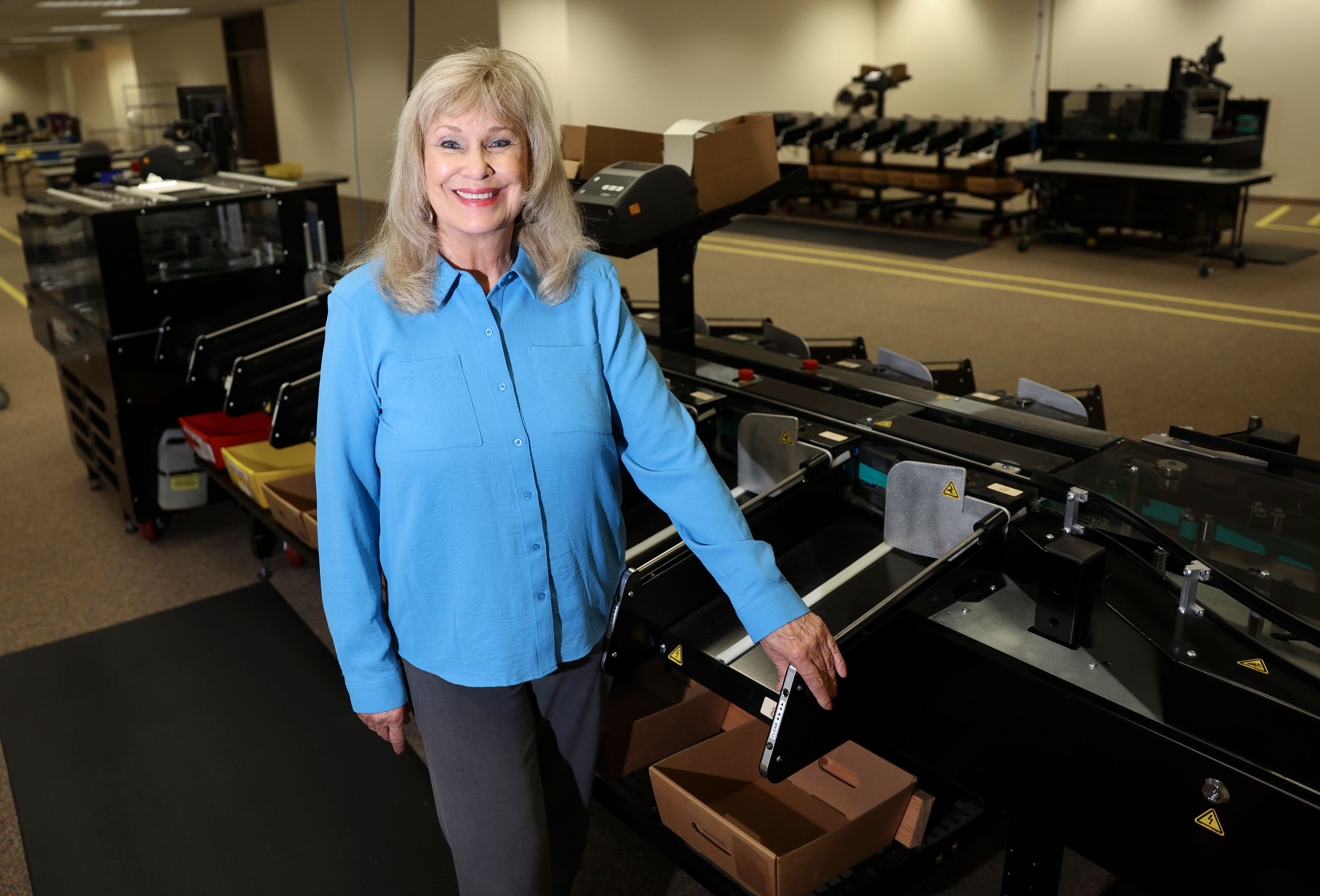 Salt Lake County Clerk Sherrie Swensen, who will be retiring after 32 years of service, poses for a portrait by a ballot sorting machine at the Salt Lake County Government Center in Salt Lake City on Aug. 11.