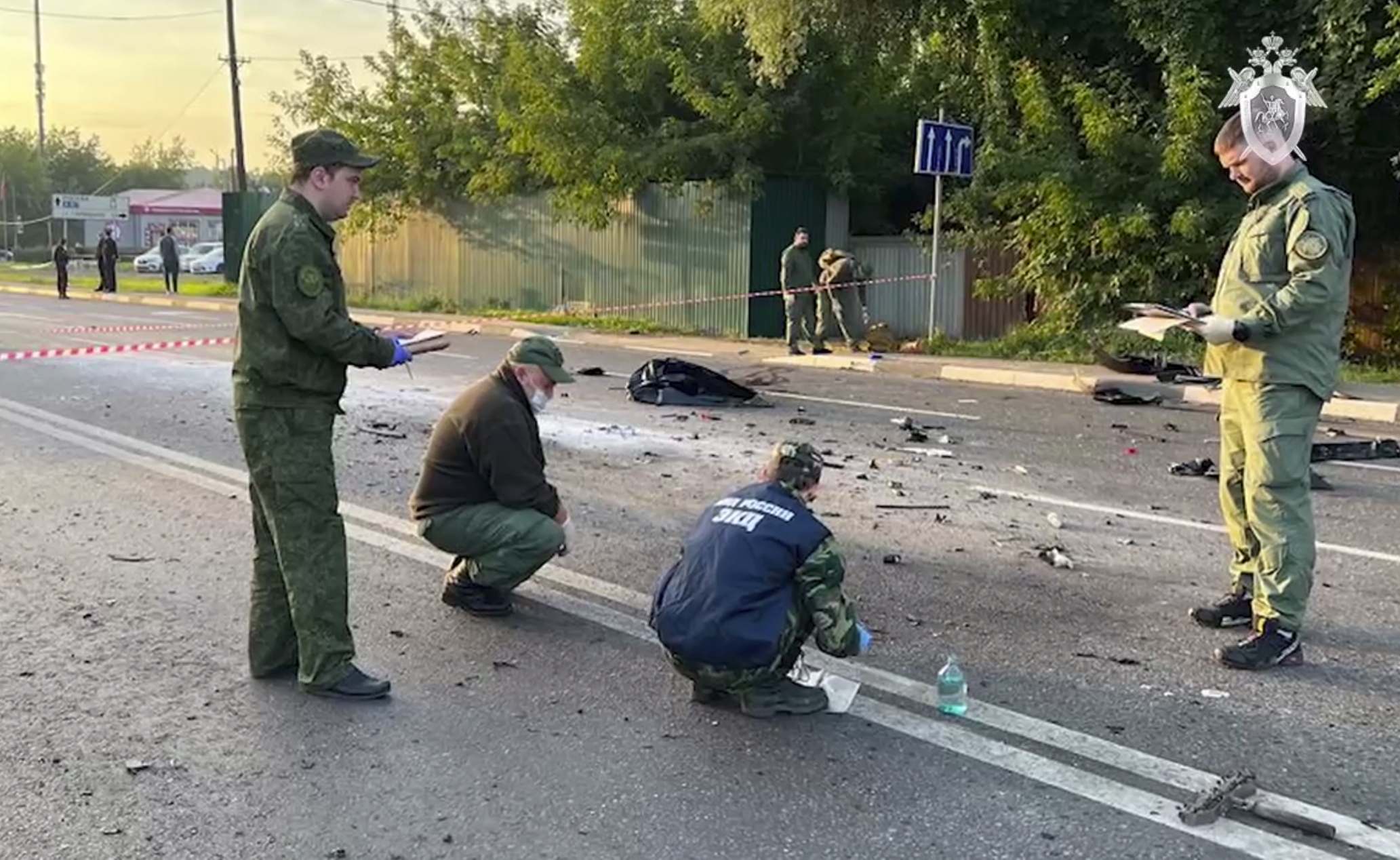 In this handout photo taken from video on Sunday, investigators work on the site of an explosion of a car driven by Daria Dugina outside Moscow.
