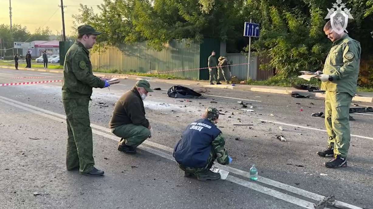 In this handout photo taken from video on Sunday, investigators work on the site of an explosion of a car driven by Daria Dugina outside Moscow.