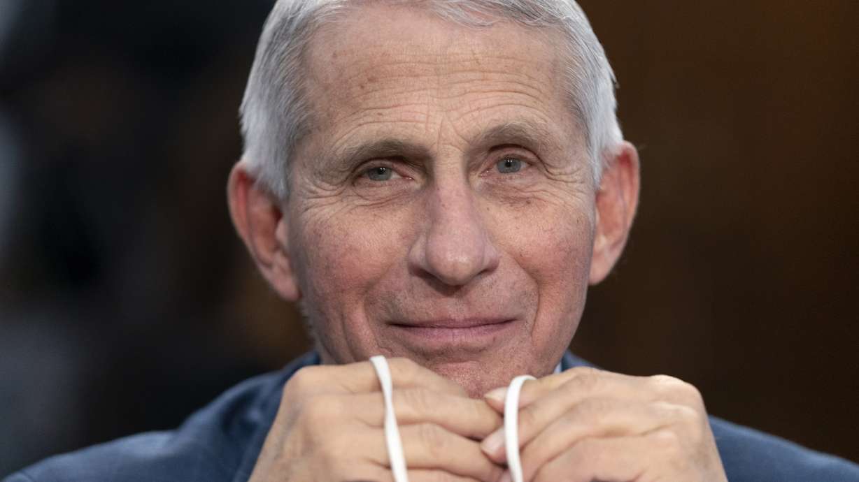 Dr. Anthony Fauci, director of the National Institute of Allergy and Infectious Diseases, holds his face mask as he attends a House subcommittee hearing May 11 on Capitol Hill in Washington. Fauci announced Monday he will depart the federal government in December.