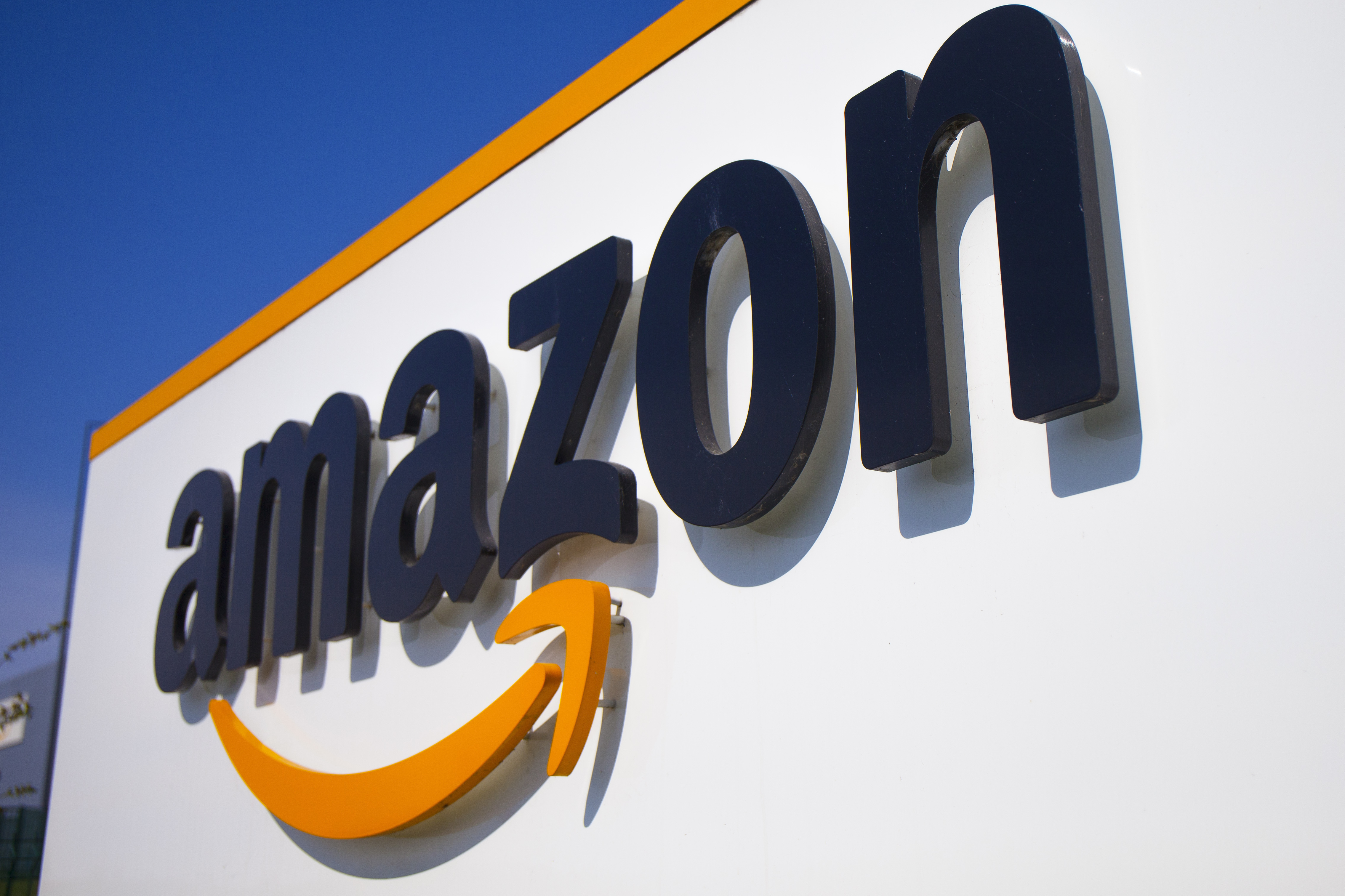 The Amazon logo is seen in Douai, northern France, April 16, 2020. In August, Amazon said it will spend billions of dollars in two gigantic acquisitions that, if approved, will broaden its ever growing presence in the lives of consumers. This time, the company is targeting two areas: health care and the "smart home." 