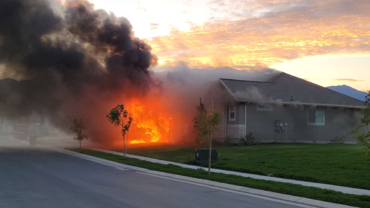 An Eagle Mountain home is suspected to be a total loss after a "very heavily involved" house fire Monday night, firefighters said.