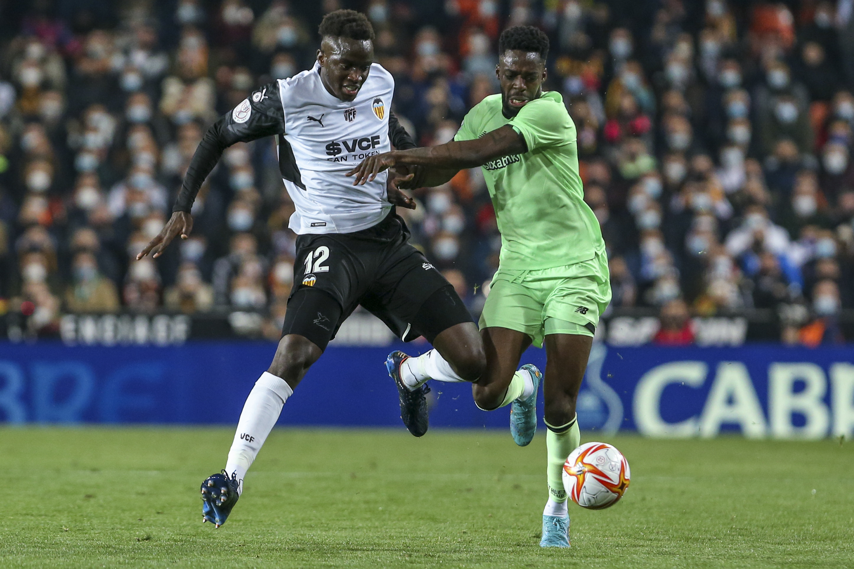 FILE - Valencia's Mouctar Diakhaby, left, vies for the ball with Athletic Bilbao's Inaki Williams during a Spanish Copa del Rey semifinal second leg soccer match between Valencia and Athletic Bilbao at Mestalla stadium in Valencia, Spain, Wednesday, March 2, 2022. Williams is enjoying yet another season as a starter for Athletic Bilbao. Williams’ spot with Spain’s national team was never assured, though, so when the call to play for Ghana came, his decision wasn’t that hard to make. 