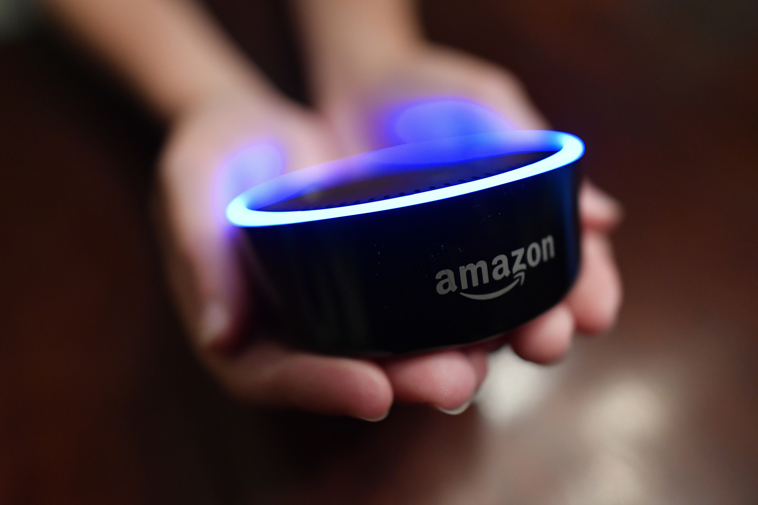 A child holds his Amazon Echo Dot in Kennesaw, Ga., Aug. 16, 2018. From what you buy online, to how you remember tasks, to when you monitor your doorstep, Amazon is seemingly everywhere.