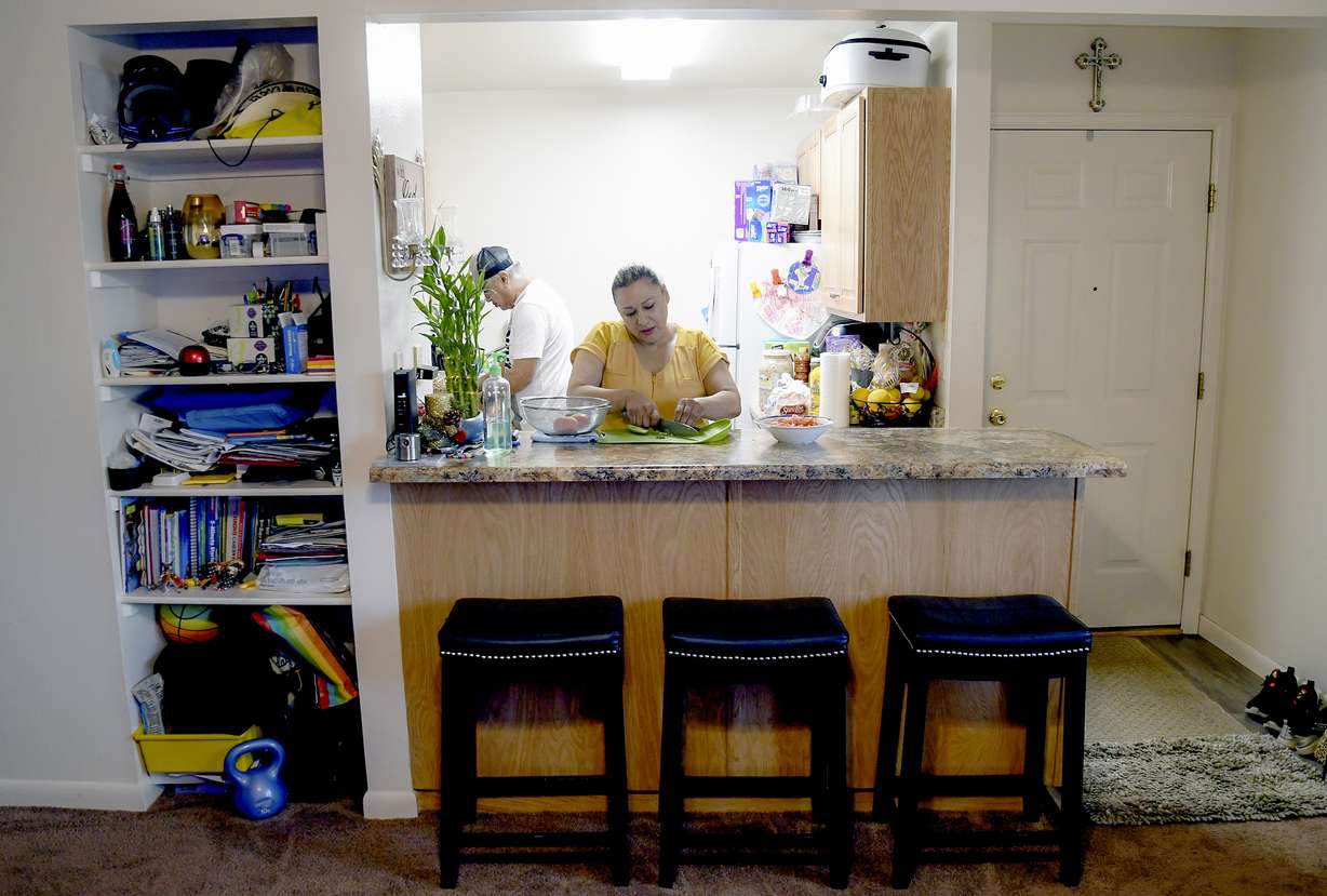 Susana Rivera prepares food in her apartment, Aug. 3, in Steamboat Springs, Colo.
