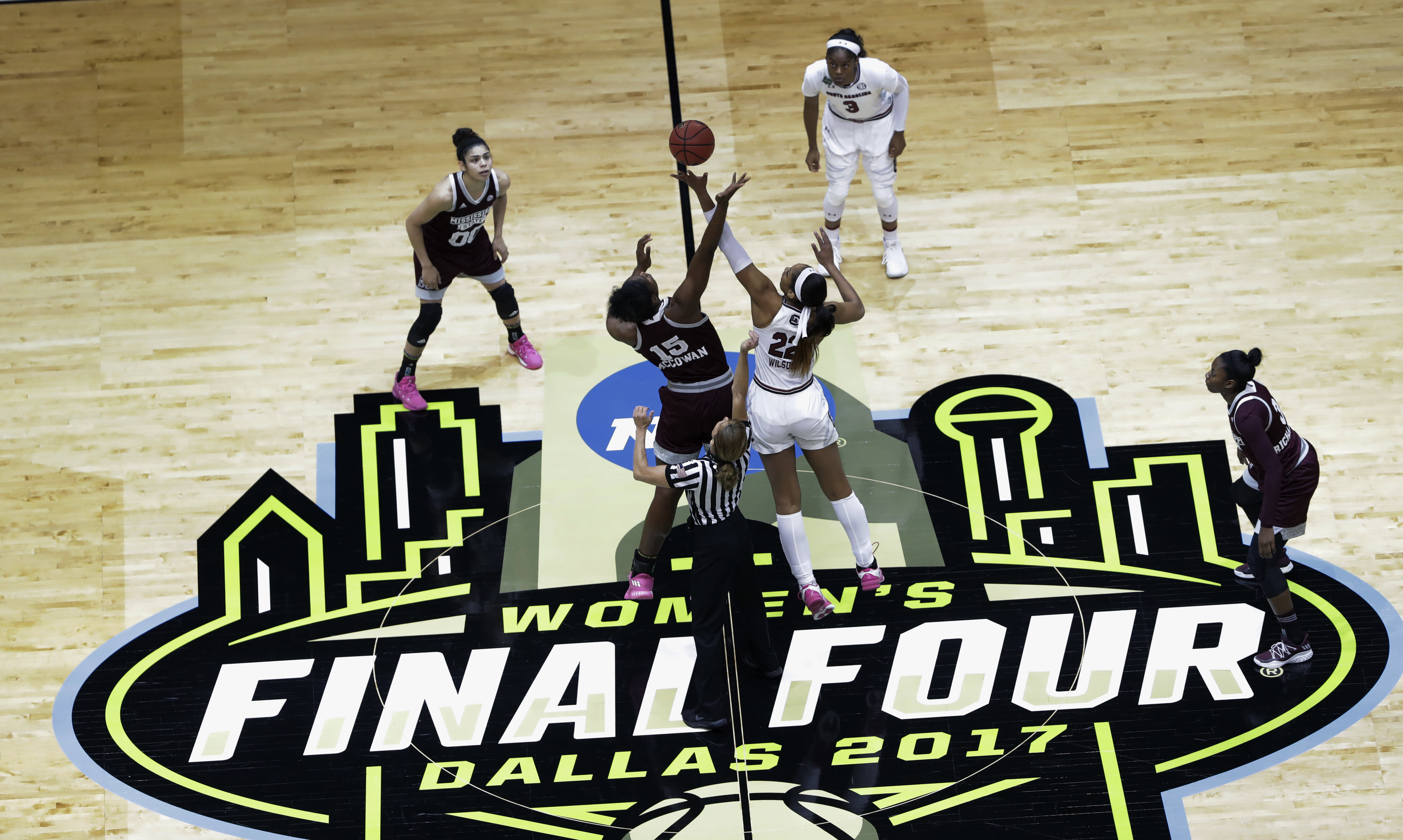 FILE - Mississippi State center Teaira McCowan (15) and South Carolina forward A'ja Wilson (22) reach for the ball on the opening tipoff of the final of the NCAA women's college basketball tournament Final Four, Sunday, April 2, 2017, in Dallas. The NCAA women's basketball title game will be broadcast on ABC for the first time this season. The championship game, which usually airs in primetime, will be played at 3 p.m. ET. The Final Four is in Dallas this year. 