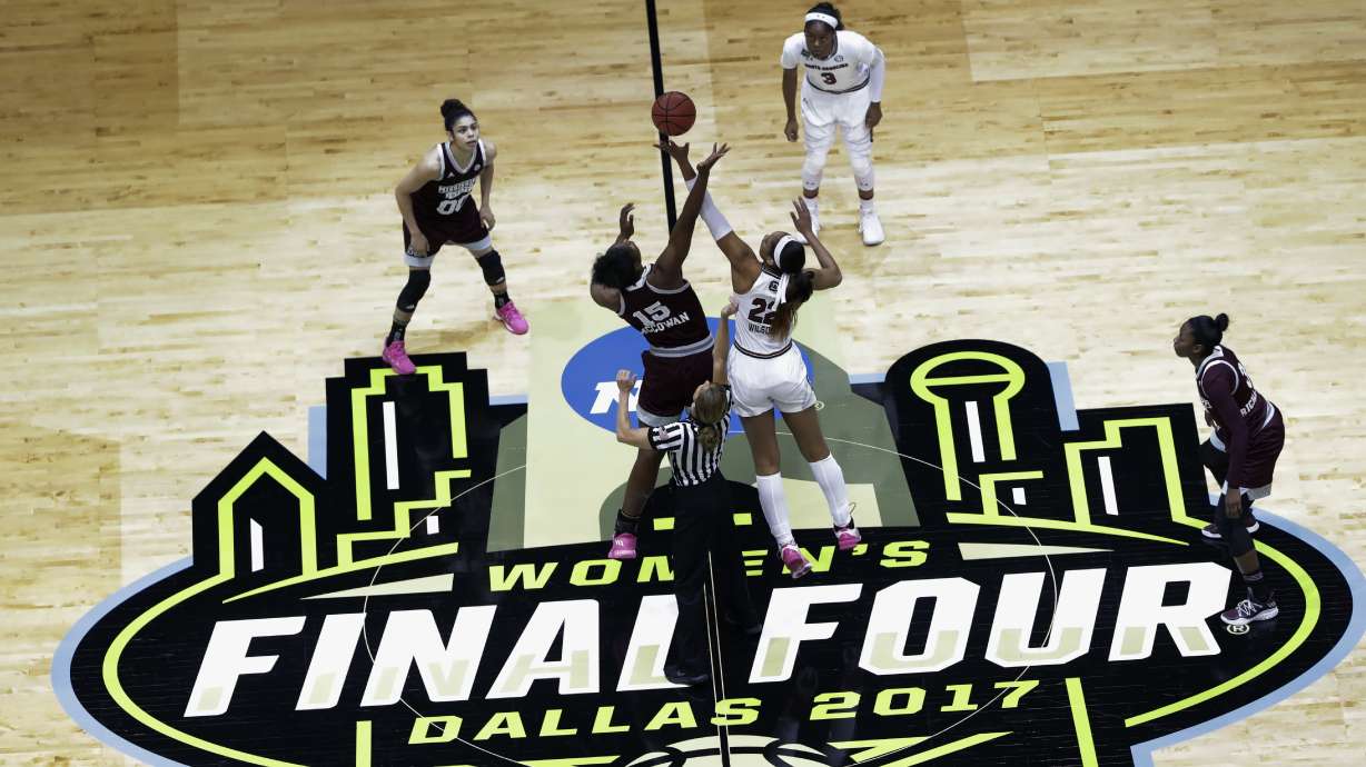 FILE - Mississippi State center Teaira McCowan (15) and South Carolina forward A'ja Wilson (22) reach for the ball on the opening tipoff of the final of the NCAA women's college basketball tournament Final Four, Sunday, April 2, 2017, in Dallas. The NCAA women's basketball title game will be broadcast on ABC for the first time this season. The championship game, which usually airs in primetime, will be played at 3 p.m. ET. The Final Four is in Dallas this year.