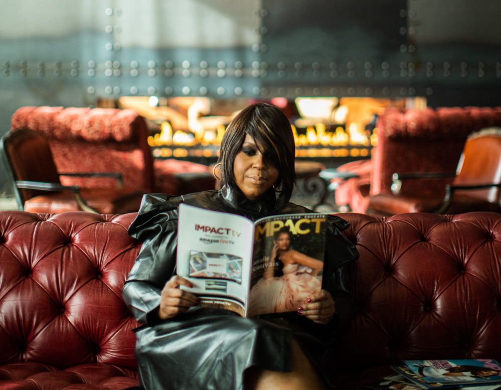 IMPACT Magazine founder and editor-in-chief Tunisha Brown holds up a copy of her magazine. Since moving to Utah in 2021, Brown has worked to empower, connect and educate Utah's Black community. 