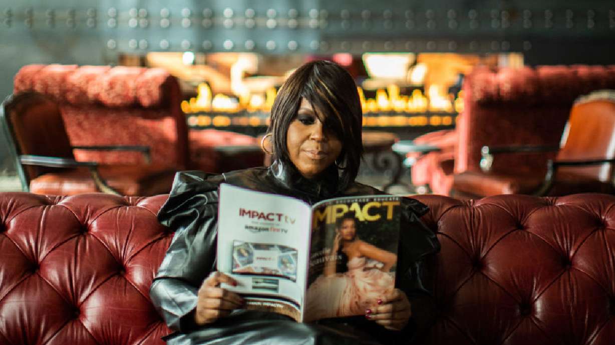 IMPACT Magazine founder and editor-in-chief Tunisha Brown holds up a copy of her magazine. Since moving to Utah in 2021, Brown has worked to empower, connect and educate Utah's Black community.