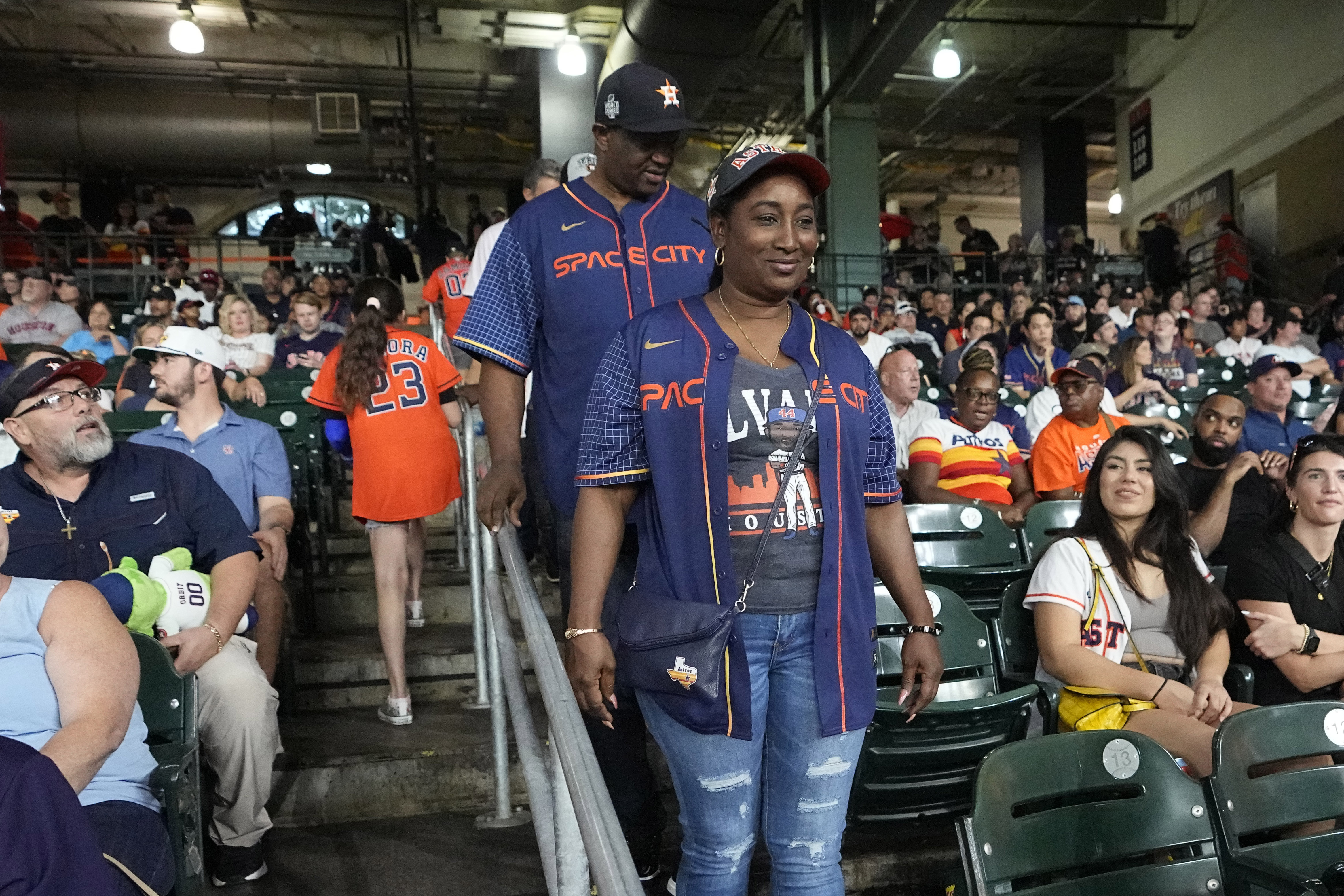 The parents of Houston Astros' Yordan Alvarez, Agustín Eduardo Álvarez Salazar, rear, and Mailyn Cadogan Reyes walk to their seats to watch the Minnesota Twins and Houston Astros play a baseball game Tuesday, Aug. 23, 2022, in Houston. Alvarez's parents got to see him play as a professional for the first time Tuesday night after arriving from Cuba Friday. 