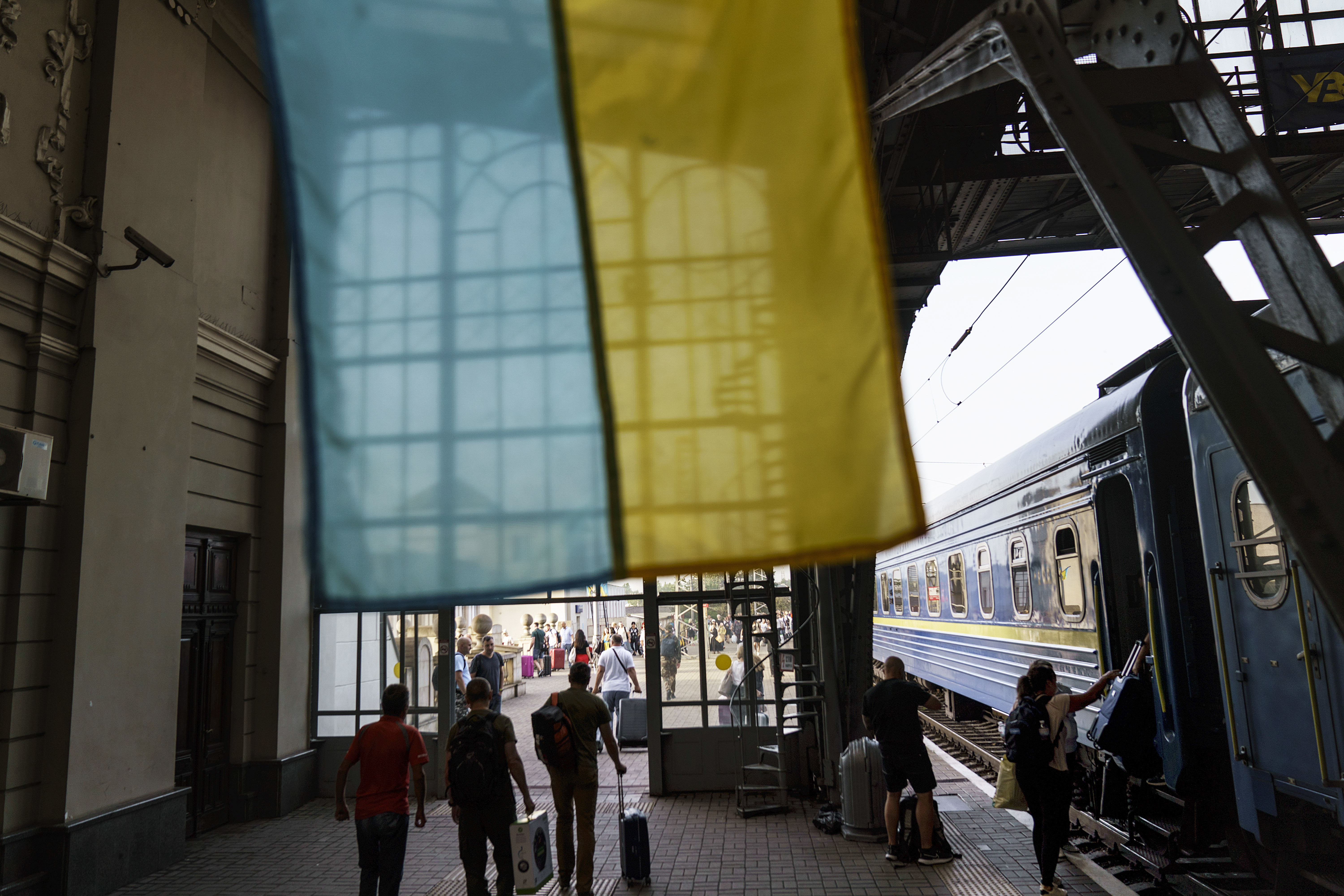 The flag of Ukraine hangs in a train station as passengers arrive in Lviv, Ukraine, on the country's Independence Day, Wednesday. Wednesday's holiday commemorates Ukraine's 1991 declaration of independence from the Soviet Union.