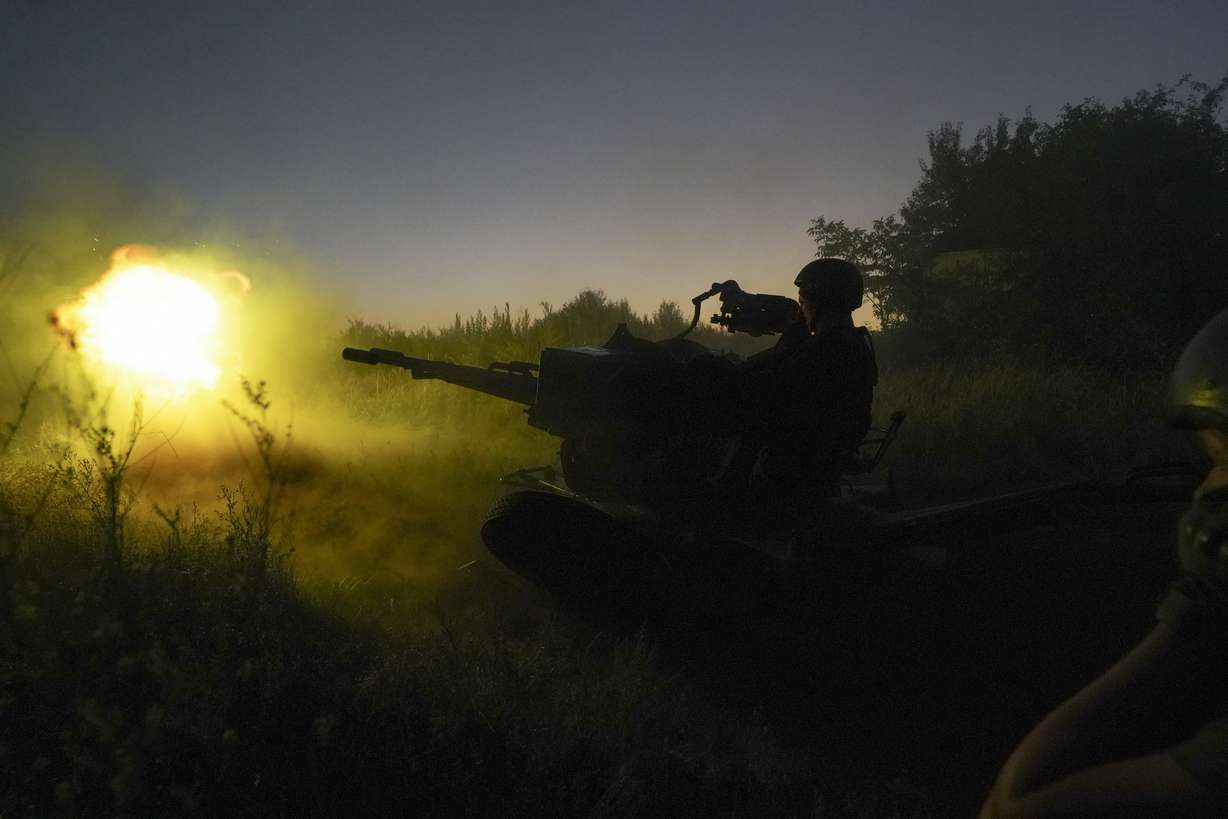 Ukrainian servicemen fire to Russian positions from anti-aircraft gun in Kharkiv region, Ukraine, early Wednesday.