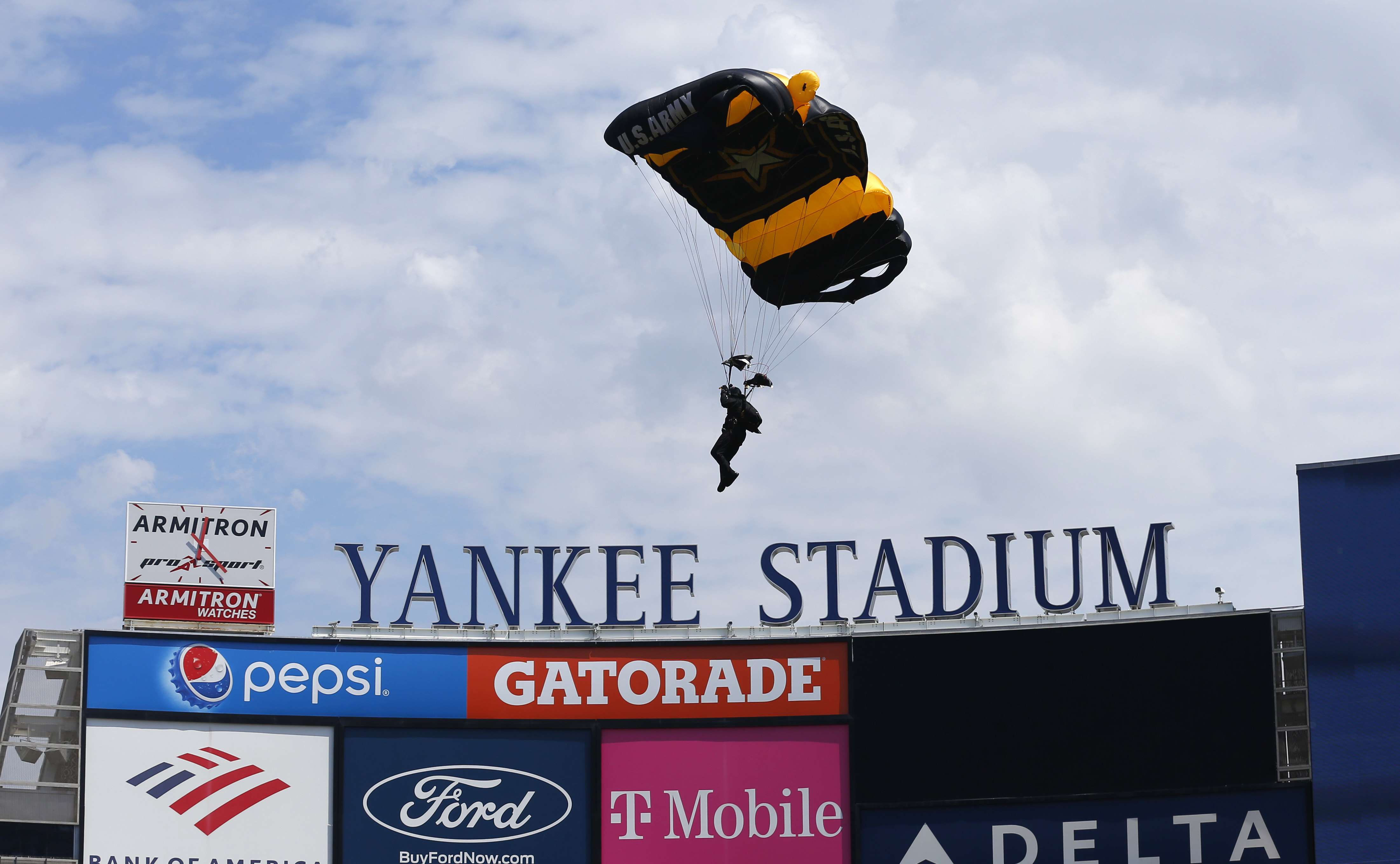Members of the U.S. Army Golden Knights parachute into Yankee Stadium before a baseball game between the Toronto Blue Jays and the New York Yankees. Saturday, Aug. 20, 2022, in New York. 