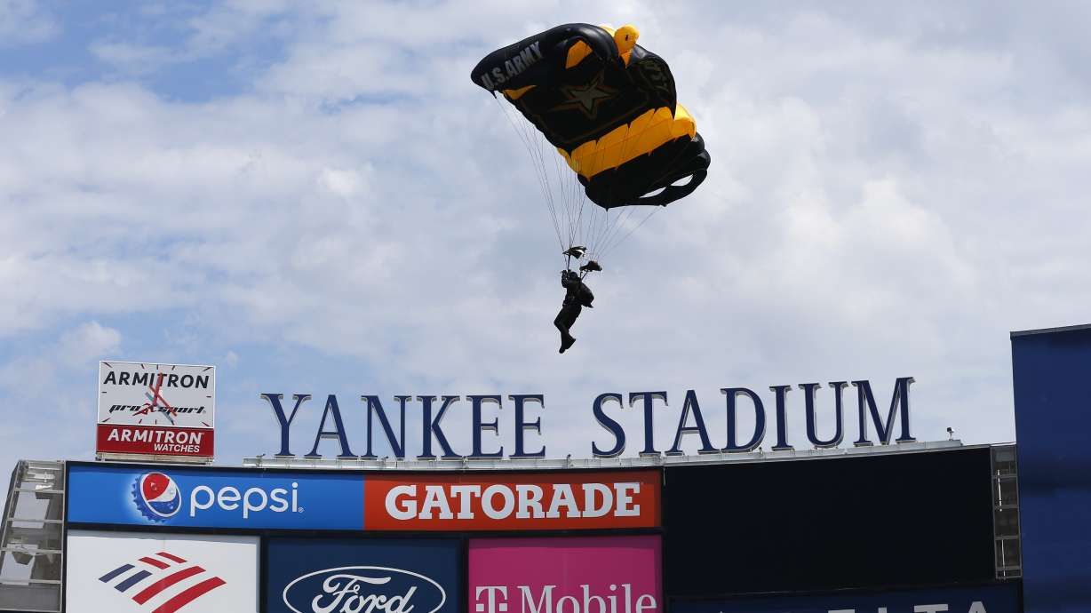 Members of the U.S. Army Golden Knights parachute into Yankee Stadium before a baseball game between the Toronto Blue Jays and the New York Yankees. Saturday, Aug. 20, 2022, in New York.