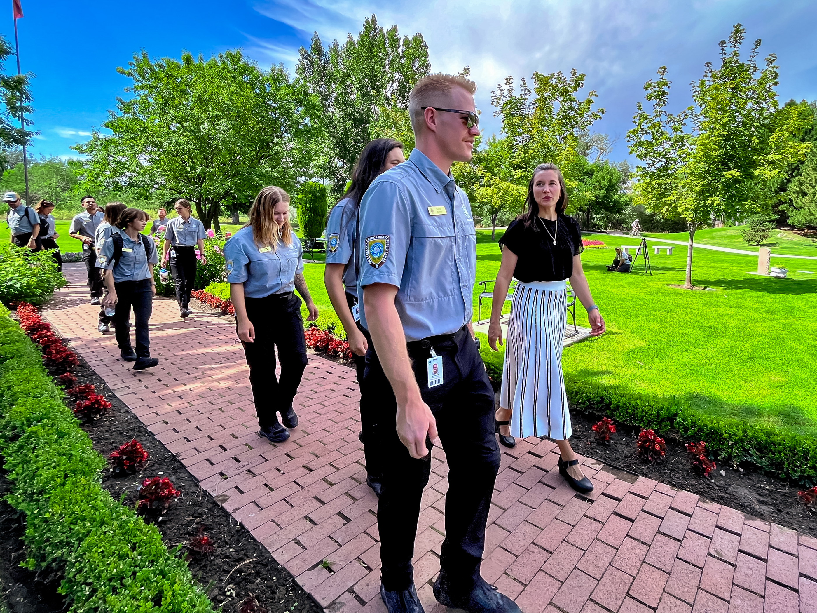 Salt Lake City Mayor Erin Mendenhall, right, speaks with members of the Salt Lake City Park Ranger Program at the International Peace Gardens in Salt Lake City Wednesday.