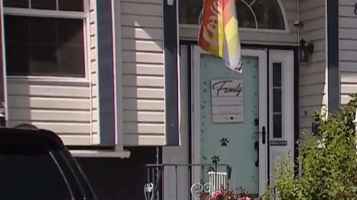 A Pride flag is displayed on July 31 at the Sandy home of a gay teen who police say was assaulted in a hate crime. Criminal charges have been dismissed because of evidentiary issues against a man accused of retaliating against the teen's family.