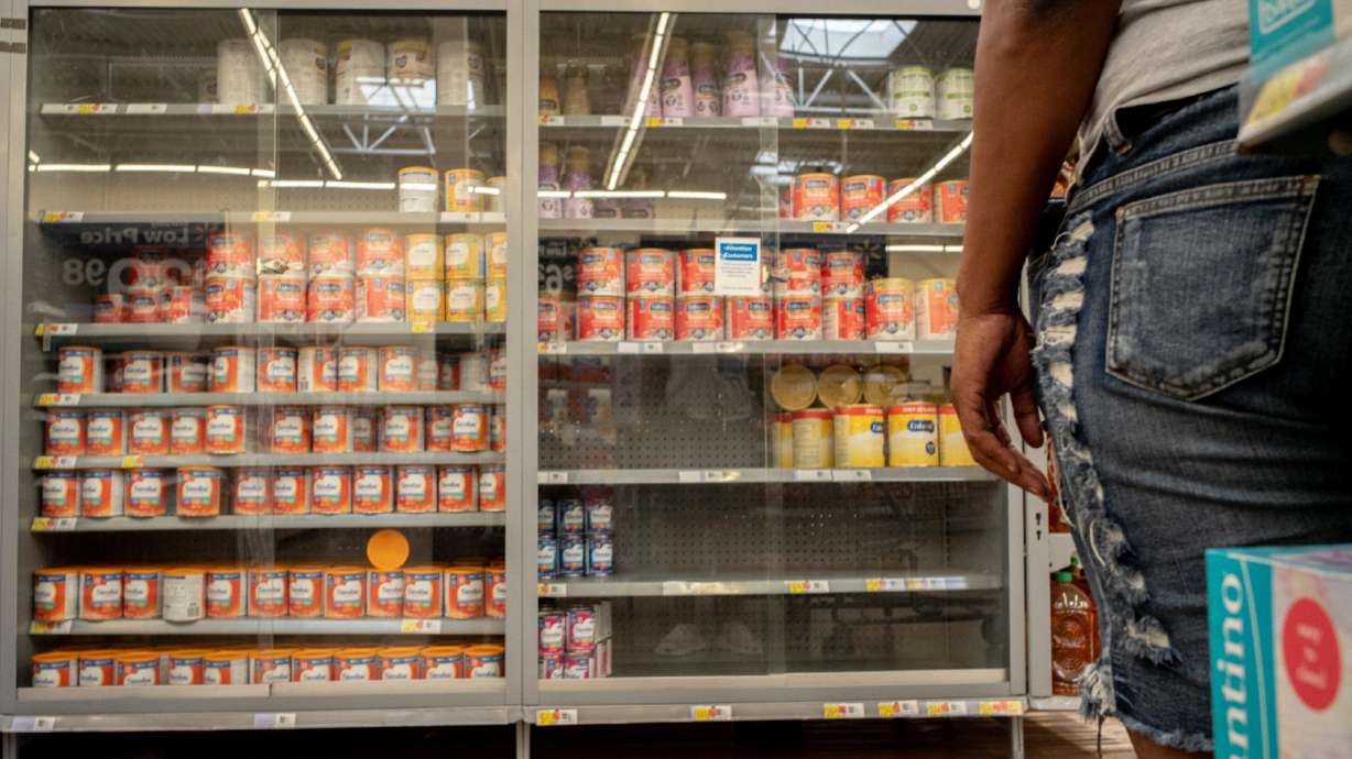 A customer stands waiting for assistance to receive baby formula in a Walmart Supercenter on July 8, in Houston. The federal government says it plans to continue to allow families who use nutrition benefits to afford baby formula to have an expanded range of options when they go to the grocery store.