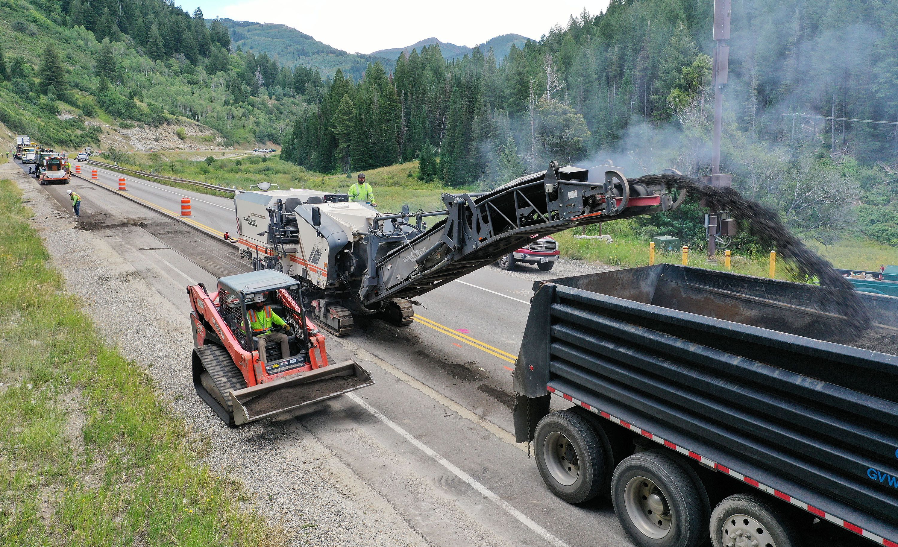 Rocky Mountain Power crews bury overhead power lines in Big Cottonwood Canyon on Wednesday. Rocky Mountain will be replacing segments of its overhead power lines with an underground conduit in Big Cottonwood, Little Cottonwood and Millcreek canyons while upgrading the existing overhead systems to be more resilient to weather and environmental factors like landslides and avalanches.