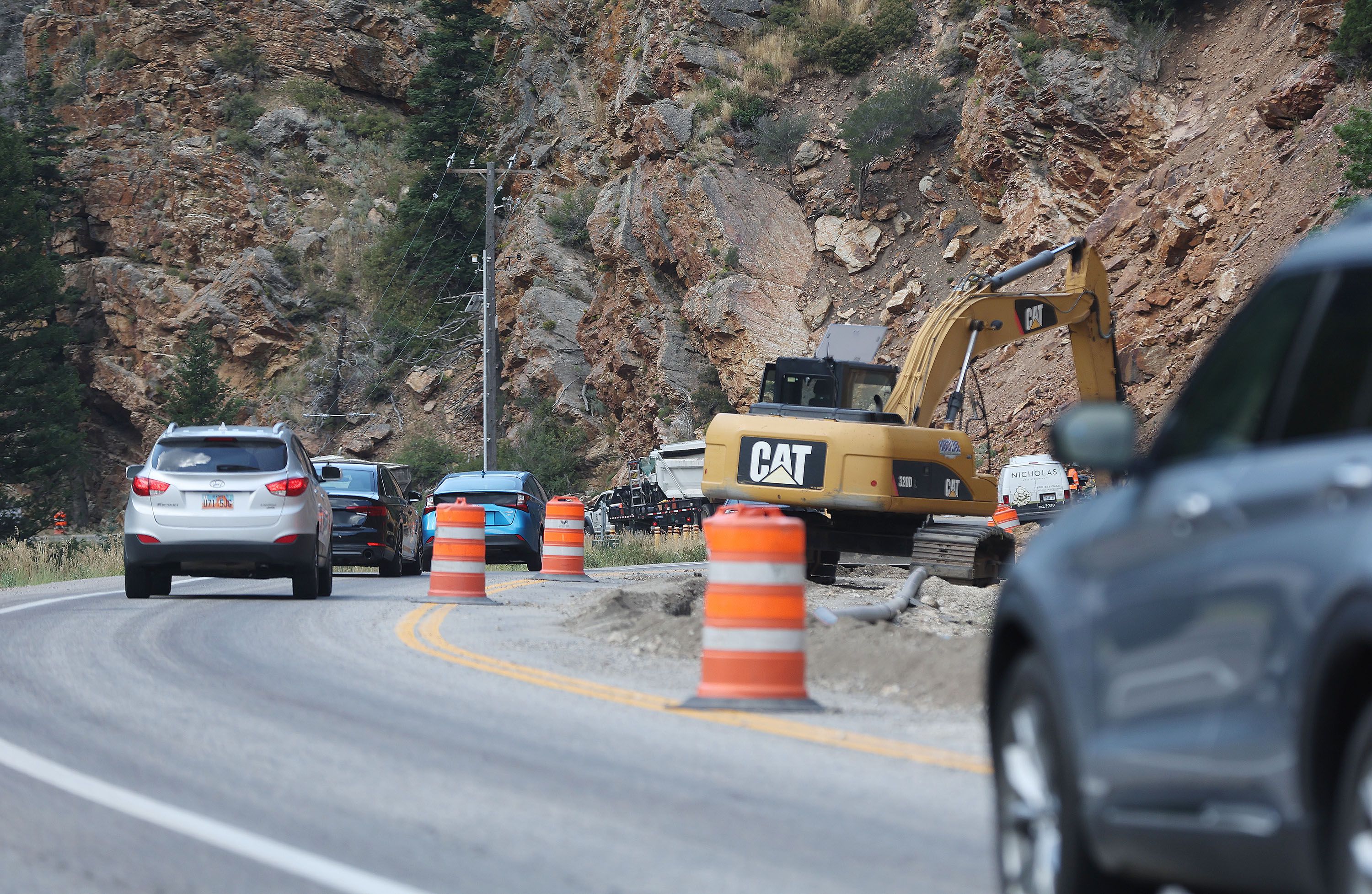 Traffic moves in a single lane as Rocky Mountain Power crews bury overhead power lines in Big Cottonwood Canyon on Wednesday. Rocky Mountain will be replacing segments of its overhead power lines with an underground conduit in Big Cottonwood, Little Cottonwood and Millcreek canyons while upgrading the existing overhead systems to be more resilient to weather and environmental factors like landslides and avalanches.