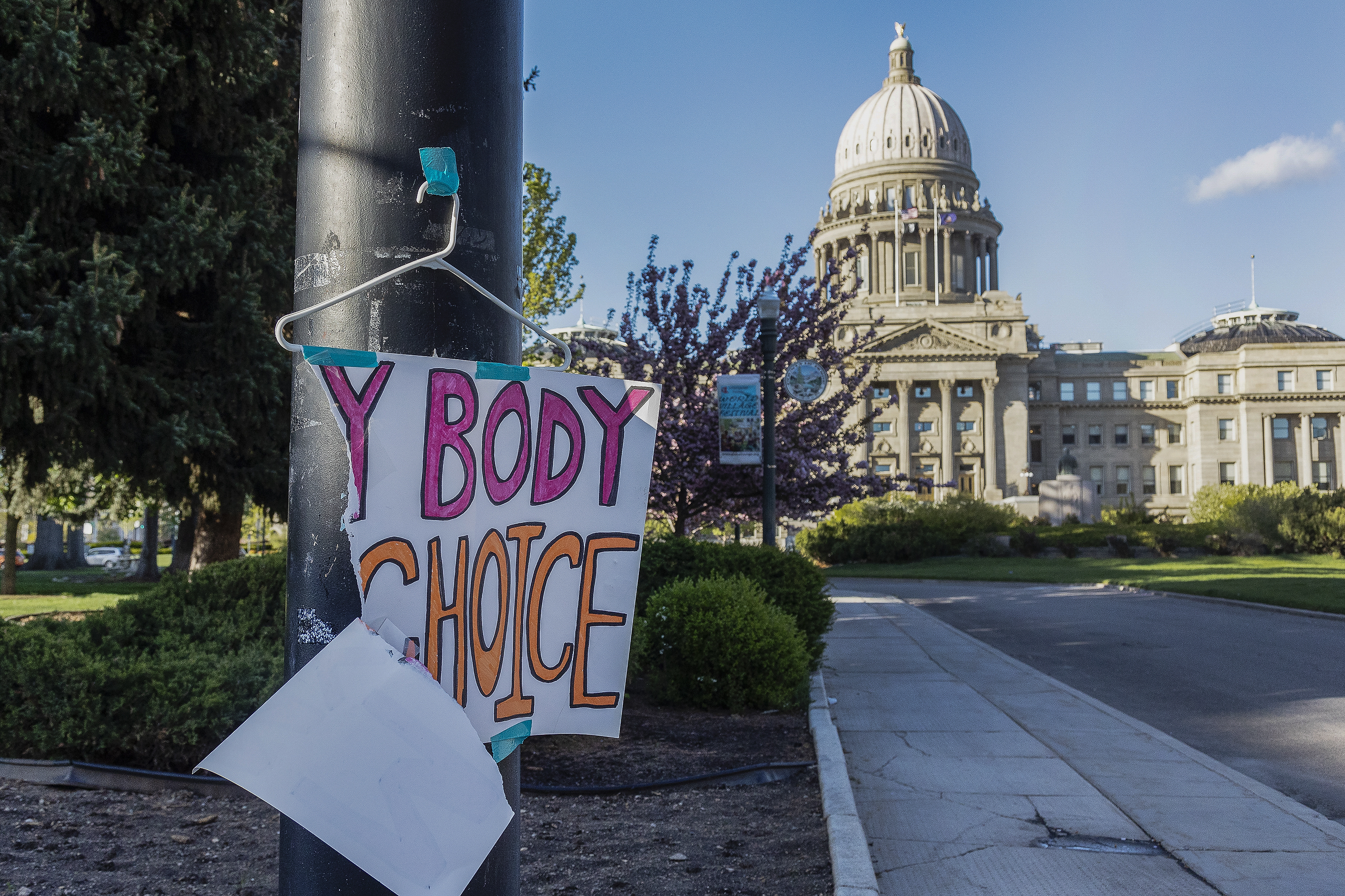 A sign reading "My body, my Choice," is taped to a hanger taped to a streetlight in front of the Idaho State Capitol Building on May 3. A federal judge has barred Idaho from enforcing a strict abortion ban in medical emergencies, clearing the way for hospitals to continue treating ectopic pregnancies and other pregnancy-related complications normally for now.