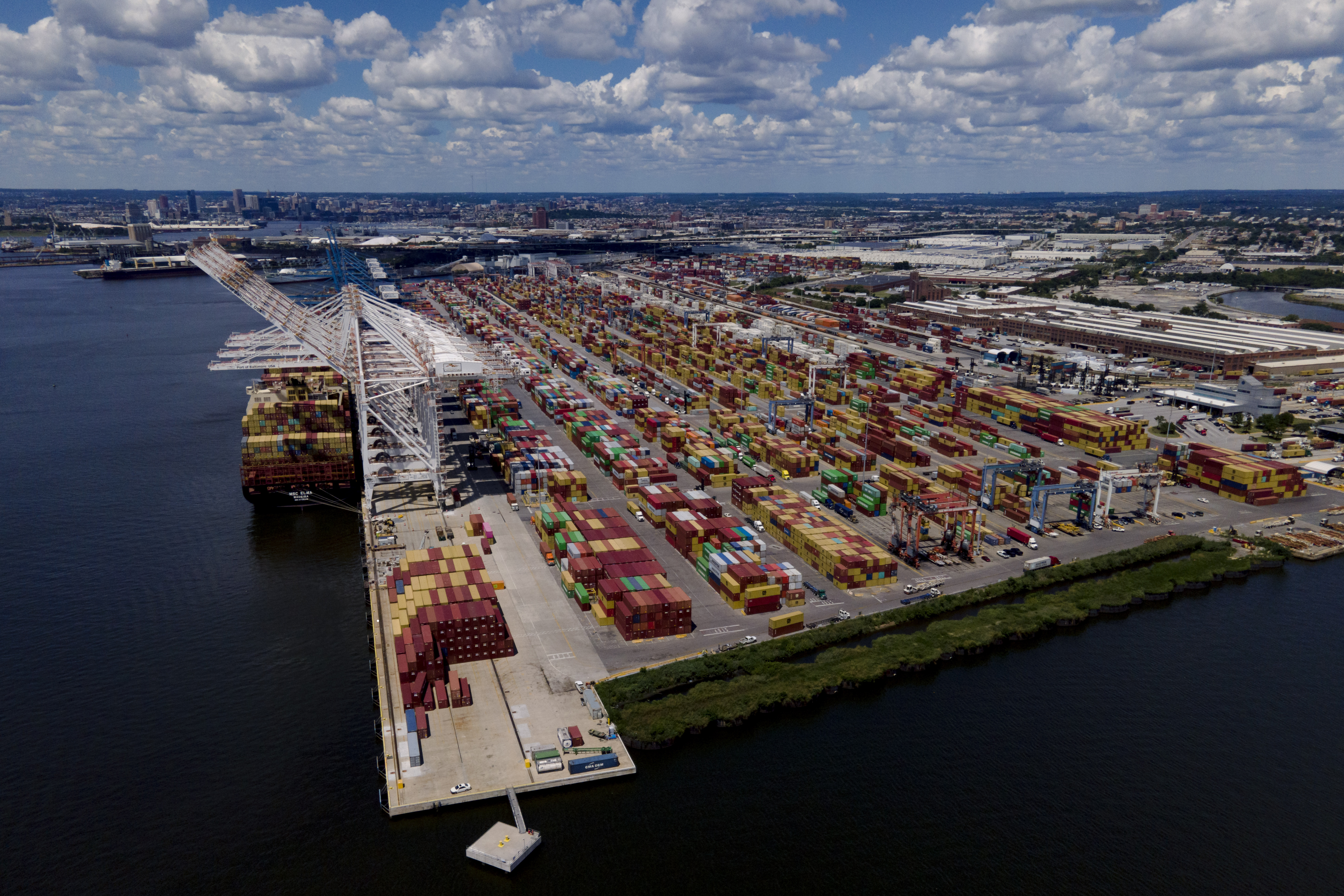 Shipping containers are stacked together at the Port of Baltimore, Aug. 12, in Baltimore. During the summer, a massive container ship pulled into port loaded with sheets of plywood, aluminum rods and radioactive material – all sourced from the fields, forests and factories of Russia.