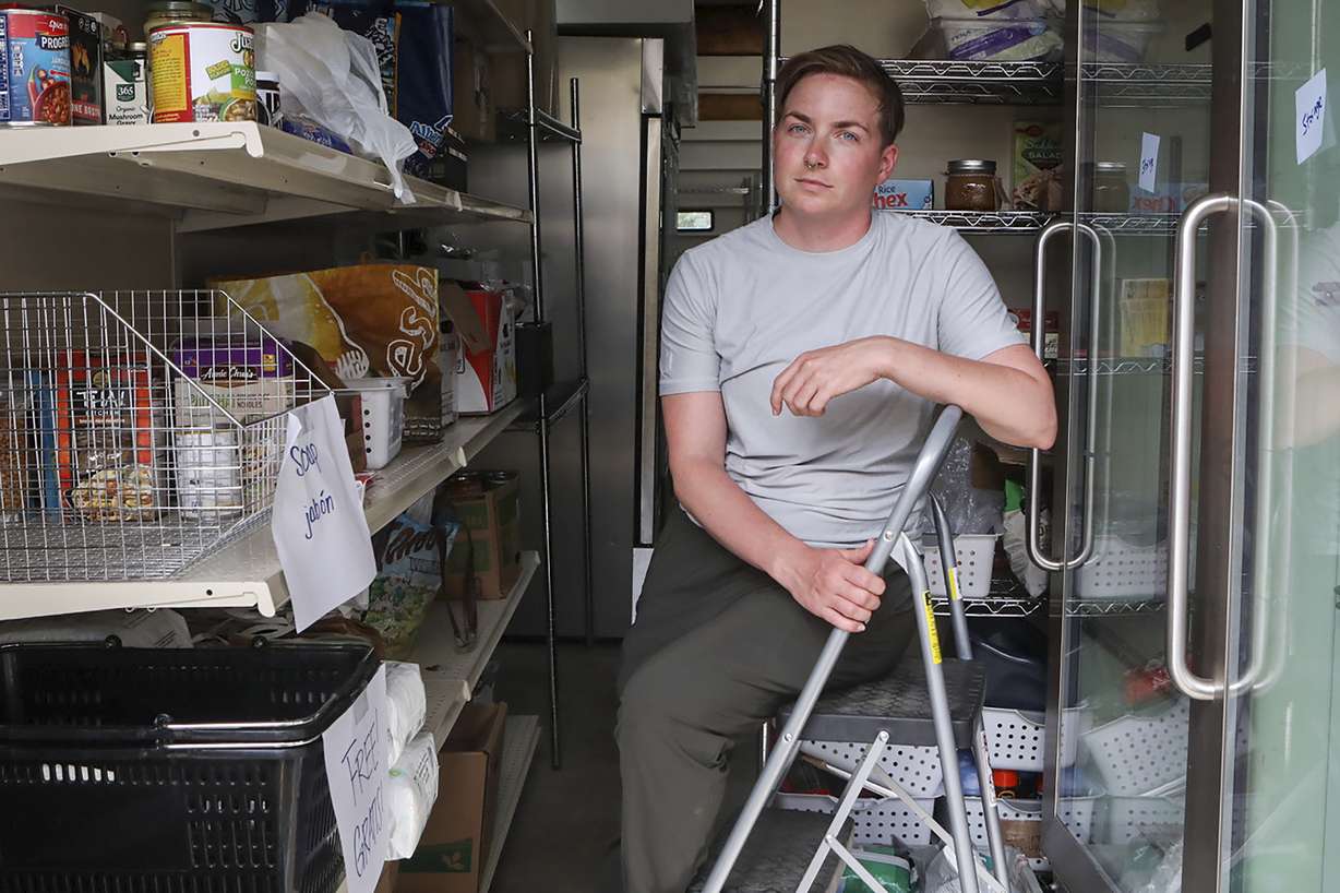 Ash Hermanowski, the food access and operations manager of the Jackson Cupboard, poses for a portrait on Wednesday, in Jackson Hole, Wyo. Hermanowksi hands out meals from a commercial garage downtown after the nonprofit was forced out of a previous location by a malfunctioning sprinkler.