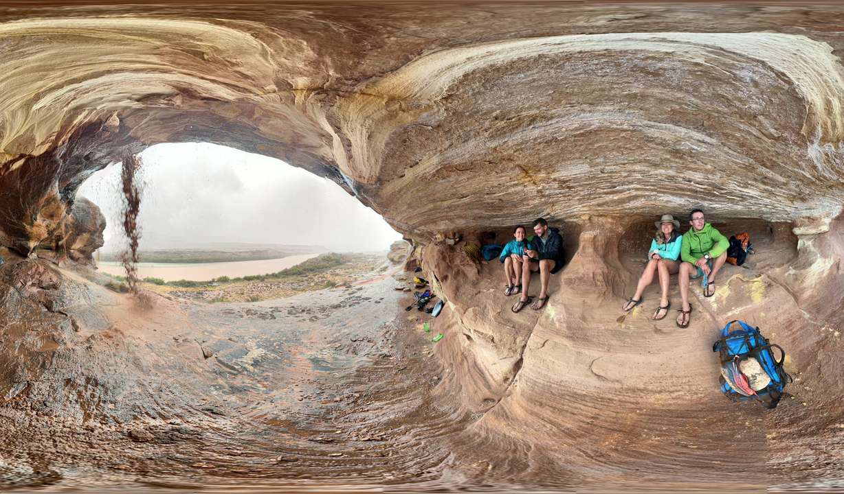 A group of hikers takes shelter during a storm in Canyonlands National Park Saturday.