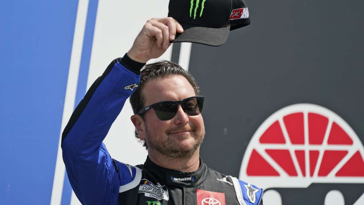FILE - NASCAR Cup Series driver Kurt Busch tips his cap prior to the NASCAR Cup Series auto race at the New Hampshire Motor Speedway, Sunday, July 17, 2022, in Loudon, N.H. Busch will miss the start of NASCAR’s playoffs with concussion-like symptoms that have sidelined him six weeks, so 23XI Racing on Thursday, Aug. 25, 2022, withdrew the medical waiver that was holding Busch’s spot in the playoffs.