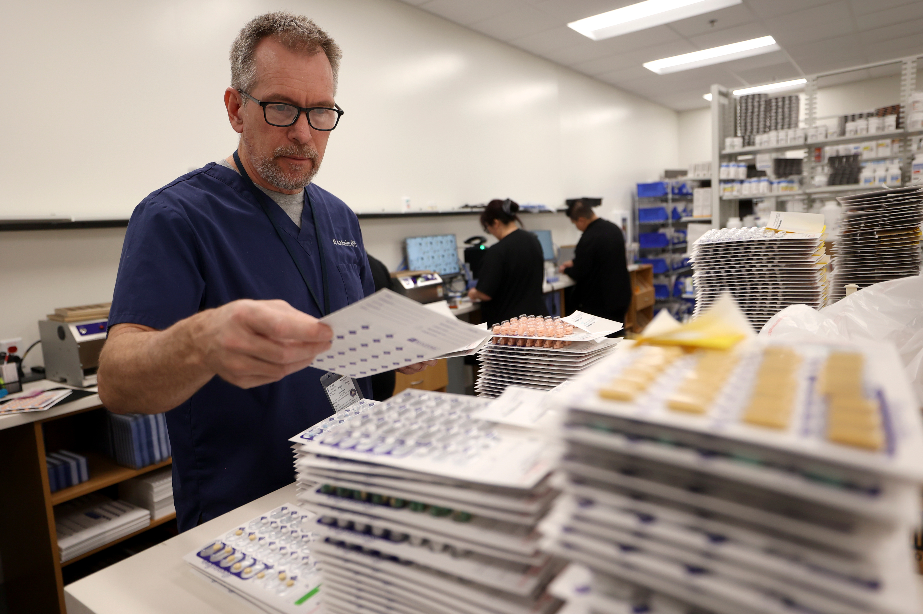 Pharmacist Mike Aasheim sorts medication blister packs at the new Utah State Correctional Facility in Salt Lake City on June 30. The Utah Department of Corrections has hit a snag in its new inmate prescription management program, causing a backlog of thousands of prescriptions that have yet to be filled, officials say.