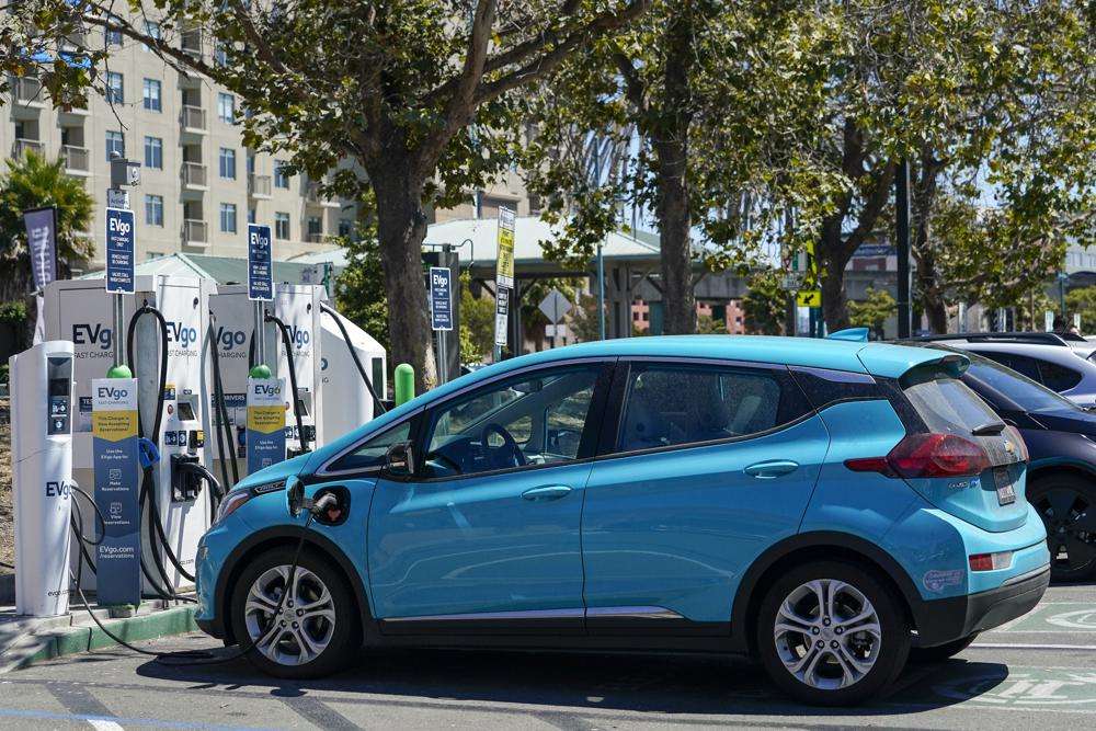 Electric vehicles can be seen charging at a shopping center in Emeryville, Calif., on Aug. 10. California is poised to require 100% of new cars, trucks and SUVs sold in the state to be powered by electricity or hydrogen by 2035, a groundbreaking climate policy likely to reshape the U.S. car market by speeding the transition to electric vehicles.