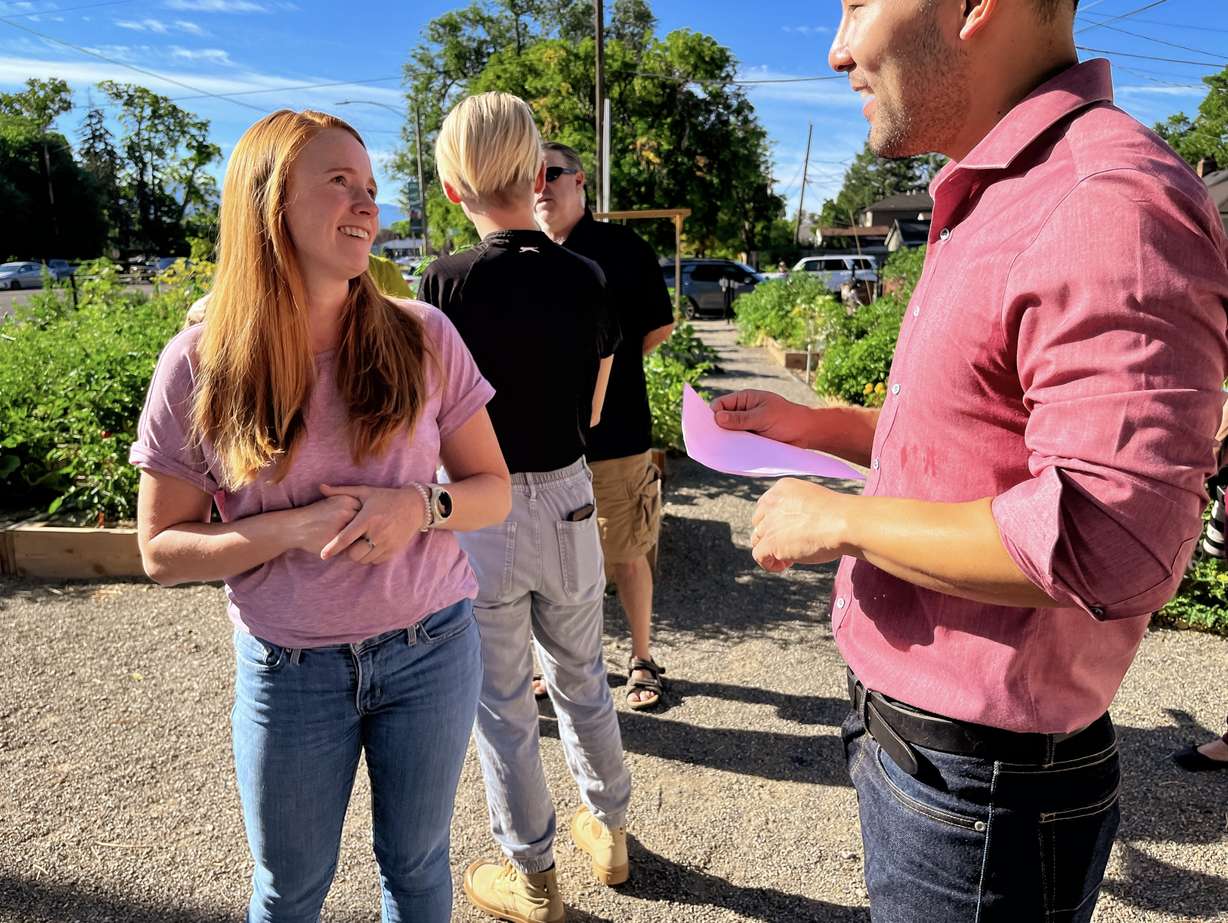 Salt Lake City resident Nichole Farley, left, speaks with Salt Lake City Councilman Darin Mano, right, at Harrison Community Garden on Thursday morning. Farley helped gather support for the garden to be funded.