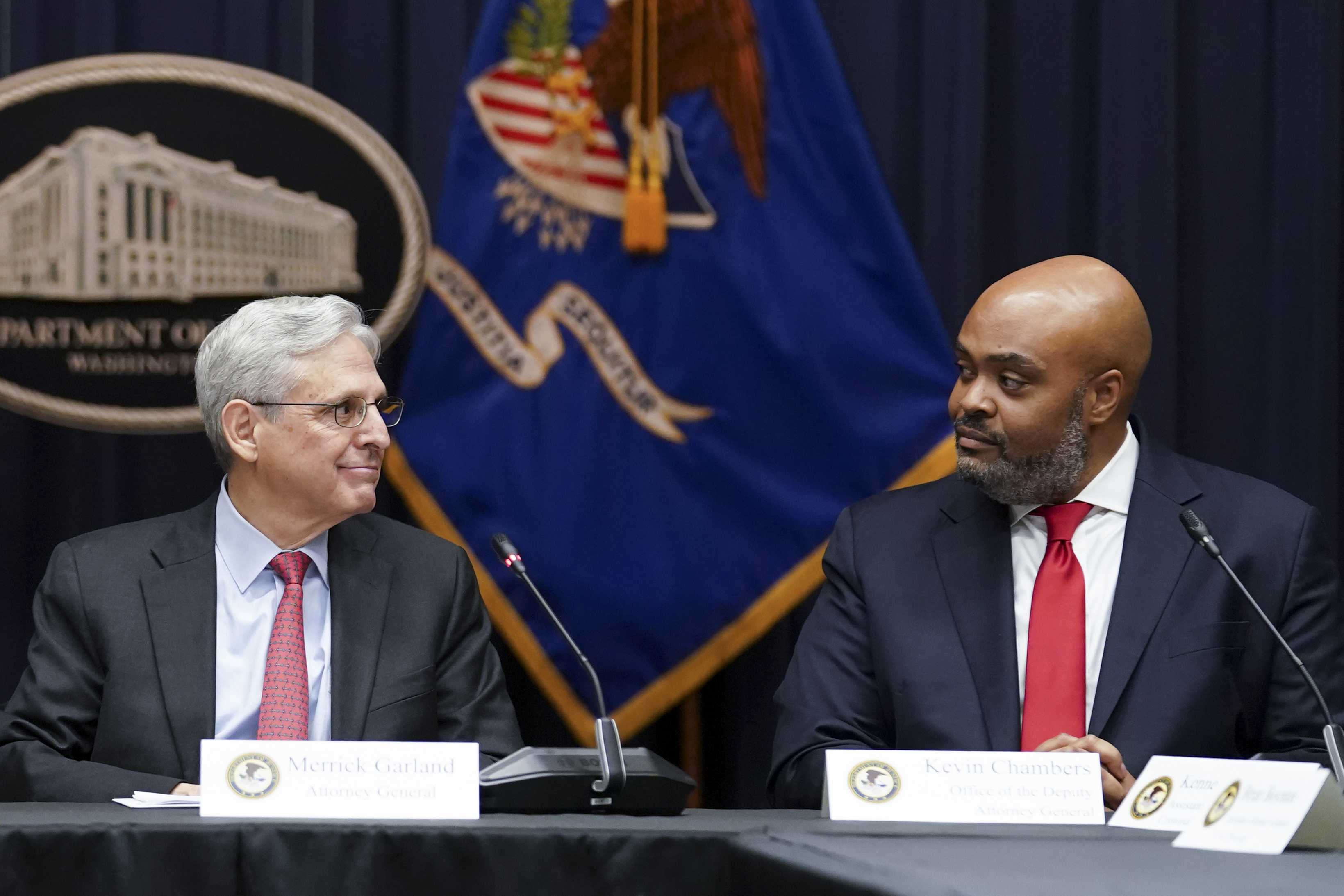 Attorney General Merrick Garland looks at federal prosecutor Kevin Chambers, right, after appointing him to be the Justice Department's chief pandemic fraud prosecutor, March 10 in Washington. The U.S. Secret Service recovered $286 million in fraudulently obtained pandemic funds to the Small Business Administration, Friday.