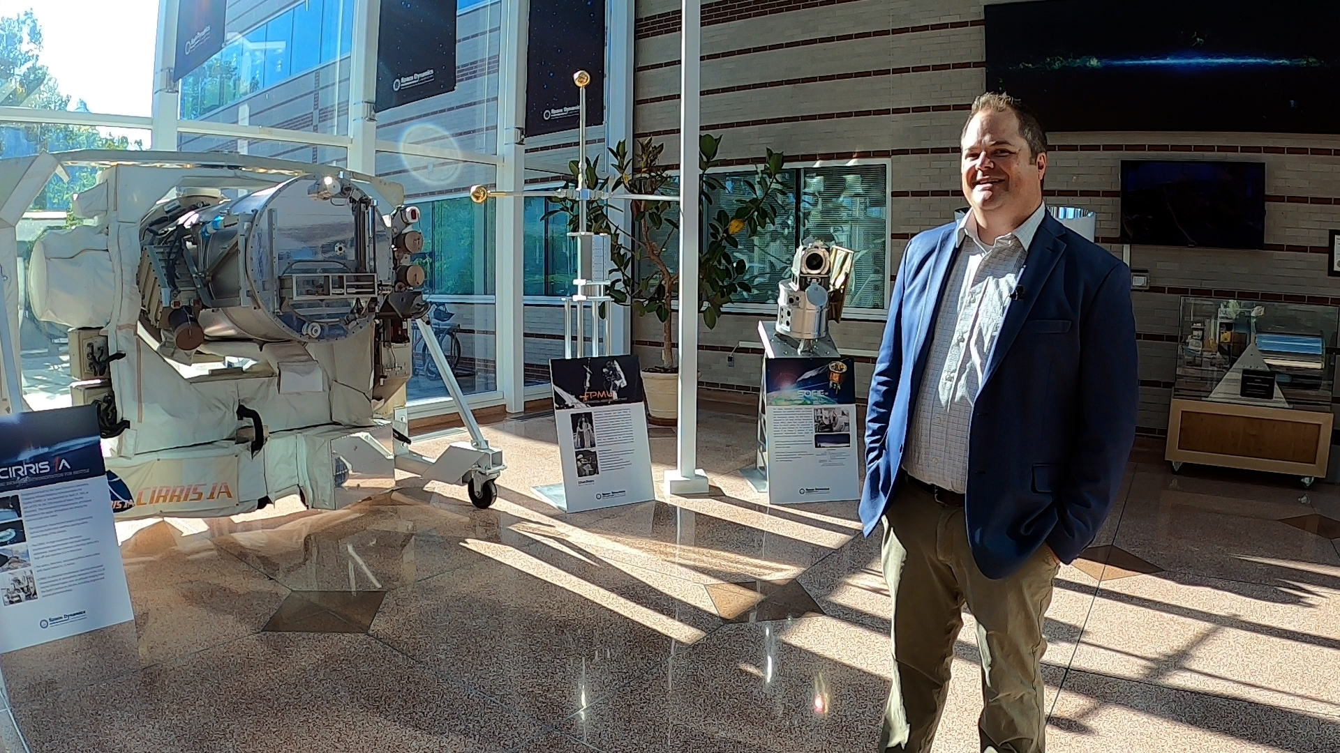 Tim Neilsen, a program manager at Space Dynamics Laboratory at the Utah State University campus, is photographed near the lab's technology on Thursday.