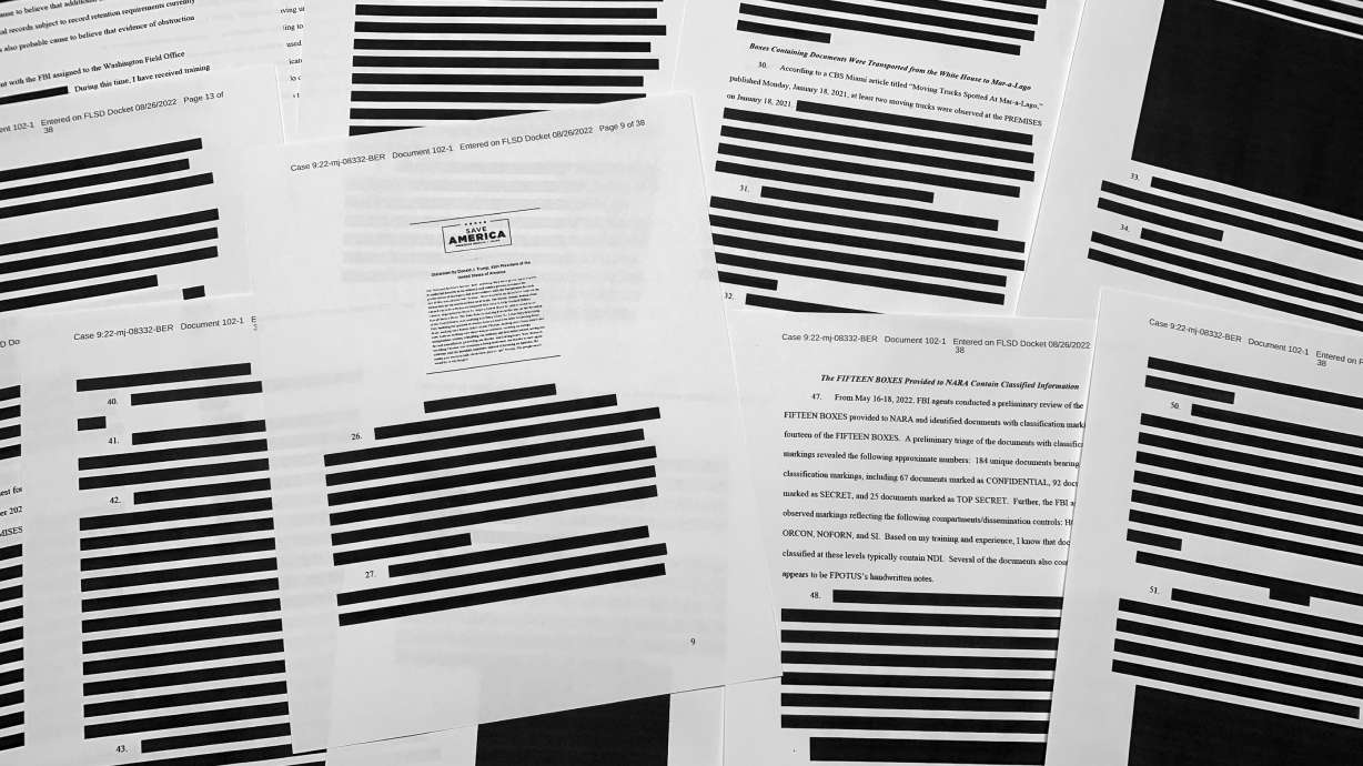 Pages from the affidavit by the FBI in support of obtaining a search warrant for former President Donald Trump's Mar-a-Lago estate are photographed Friday. U.S. Magistrate Judge Bruce Reinhart ordered the Justice Department to make public a redacted version of the affidavit it relied on when federal agents searched Trump's estate to look for classified documents.