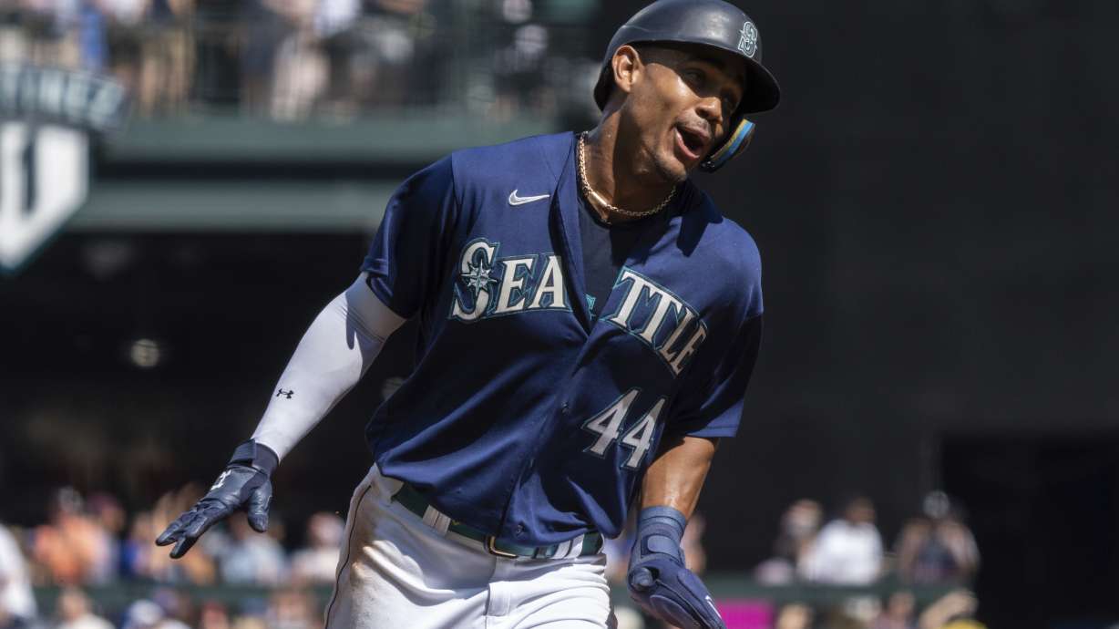 Seattle Mariners' Julio Rodriguez celebrates while rounding the bases a three-run home run by Mitch Haniger during the first inning a baseball game against the Cleveland Guardians, Thursday, Aug. 25, 2022, in Seattle.