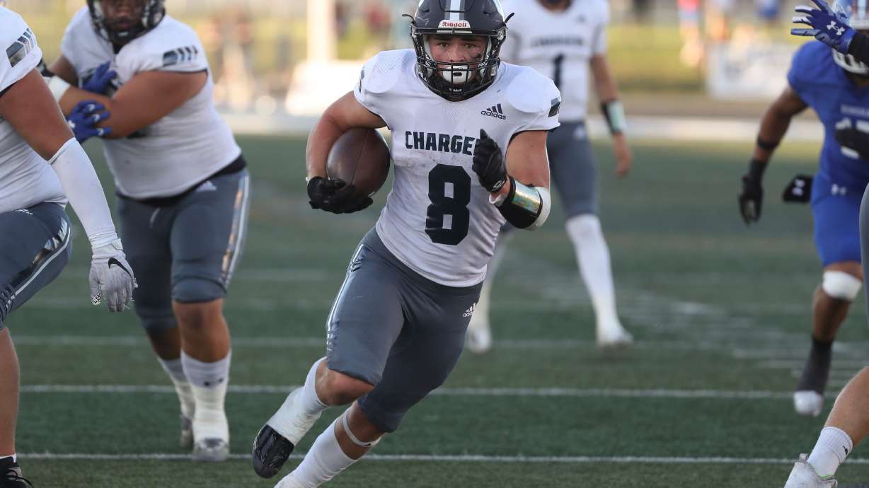 Corner Canyon’s Drew Patterson runs with the ball to score a touchdown during a varsity football game against Bingham at Bingham High School in South Jordan on Friday, Aug. 26, 2022. Corner Canyon won 38-28.