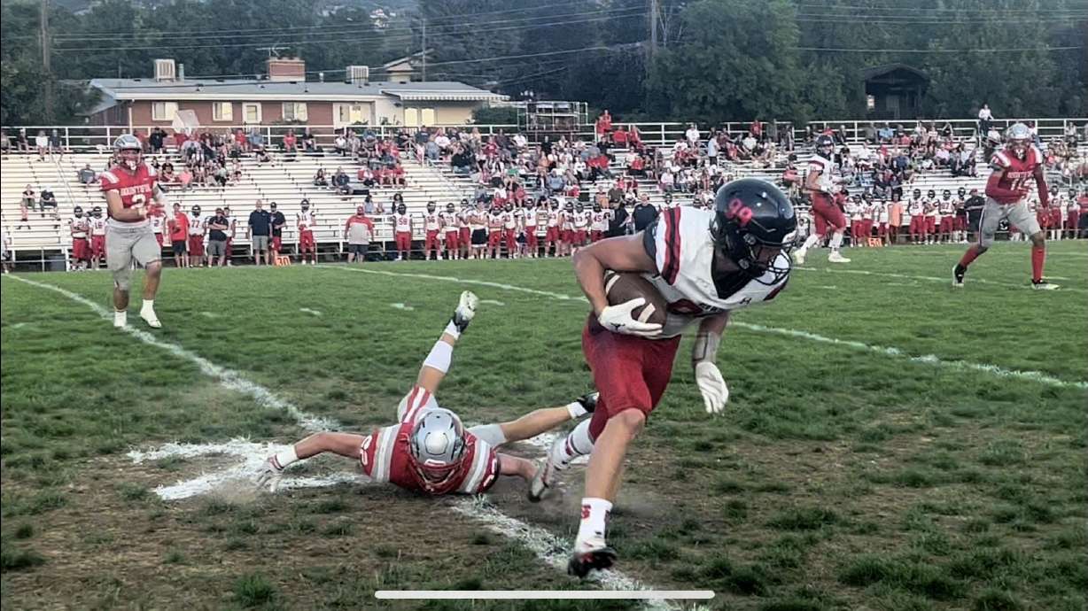 Walker Deede slips away from a tackler as Springville visits Bountiful.