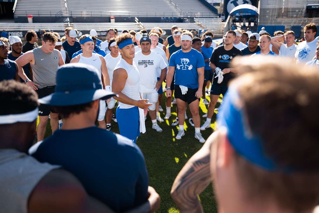 BYU quarterback Jaren Hall, center, addresses the team after wrapping up fall camp, Aug. 23, 2022 in Provo.