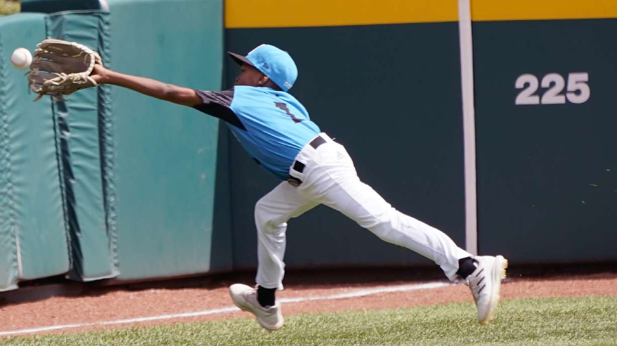 Curacao left fielder Jaythan Cordilia (1) makes a running catch on a ball hit by Taiwan's Shen Li-Chen during the fourth inning of the International Championship baseball game at the Little League World Series tournament in South Williamsport, Pa., Saturday, Aug. 27, 2022. Curacao won 1-0.
