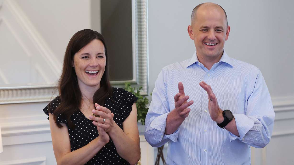 Emily McMullin, left, and her husband, Evan, applaud a piano performance by their children at their home in Highland on Aug. 5. Evan McMullin is running for U.S. Senate. The McMullins were threatened by an armed man after a campaign event in southern Utah in April, court documents say.
