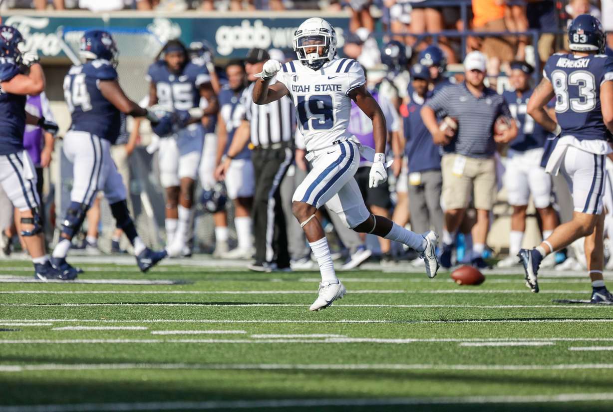 Ike Larsen (19) from the Utah Aggies celebrates after intercepting a pass from the UConn Huskies at the Maverik Stadium in Logan on Saturday, Aug. 27, 2022. The Aggies won 31-20.