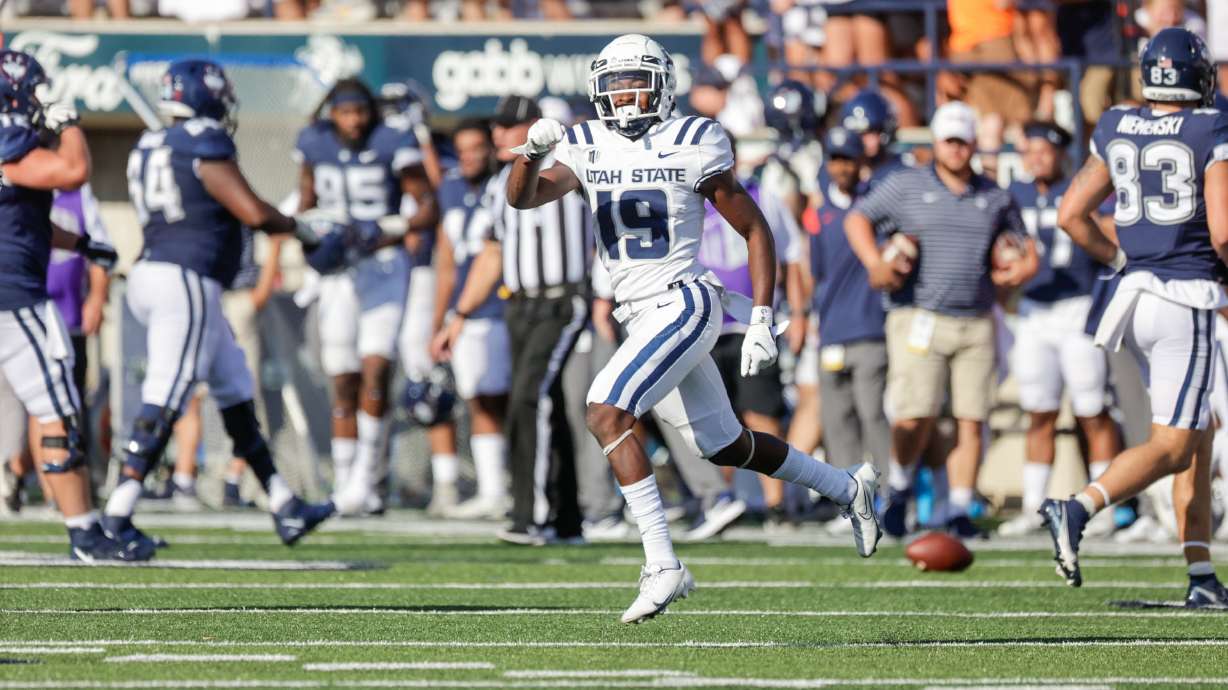 Ike Larsen (19) from the Utah Aggies celebrates after intercepting a pass from the UConn Huskies at the Maverik Stadium in Logan on Saturday, Aug. 27, 2022. The Aggies won 31-20.