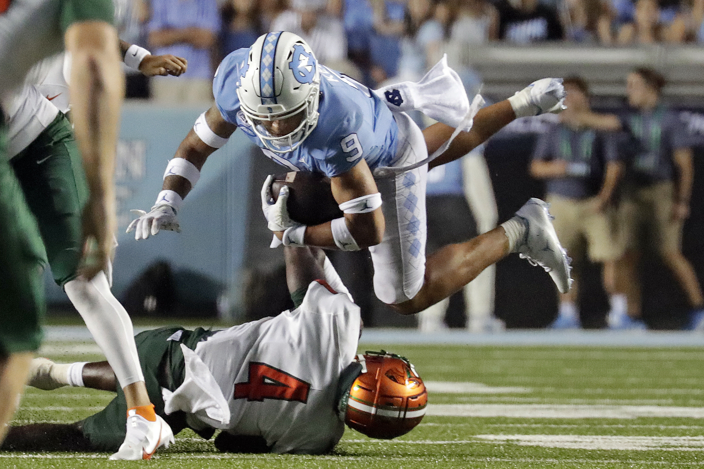North Carolina's Cam'Ron Kelly (9) is upended by Florida A&M's Kym'Mani King (4) as he runs the ball upfield during the second half of an NCAA college football game in Chapel Hill, N.C., Saturday, Aug. 27, 2022.