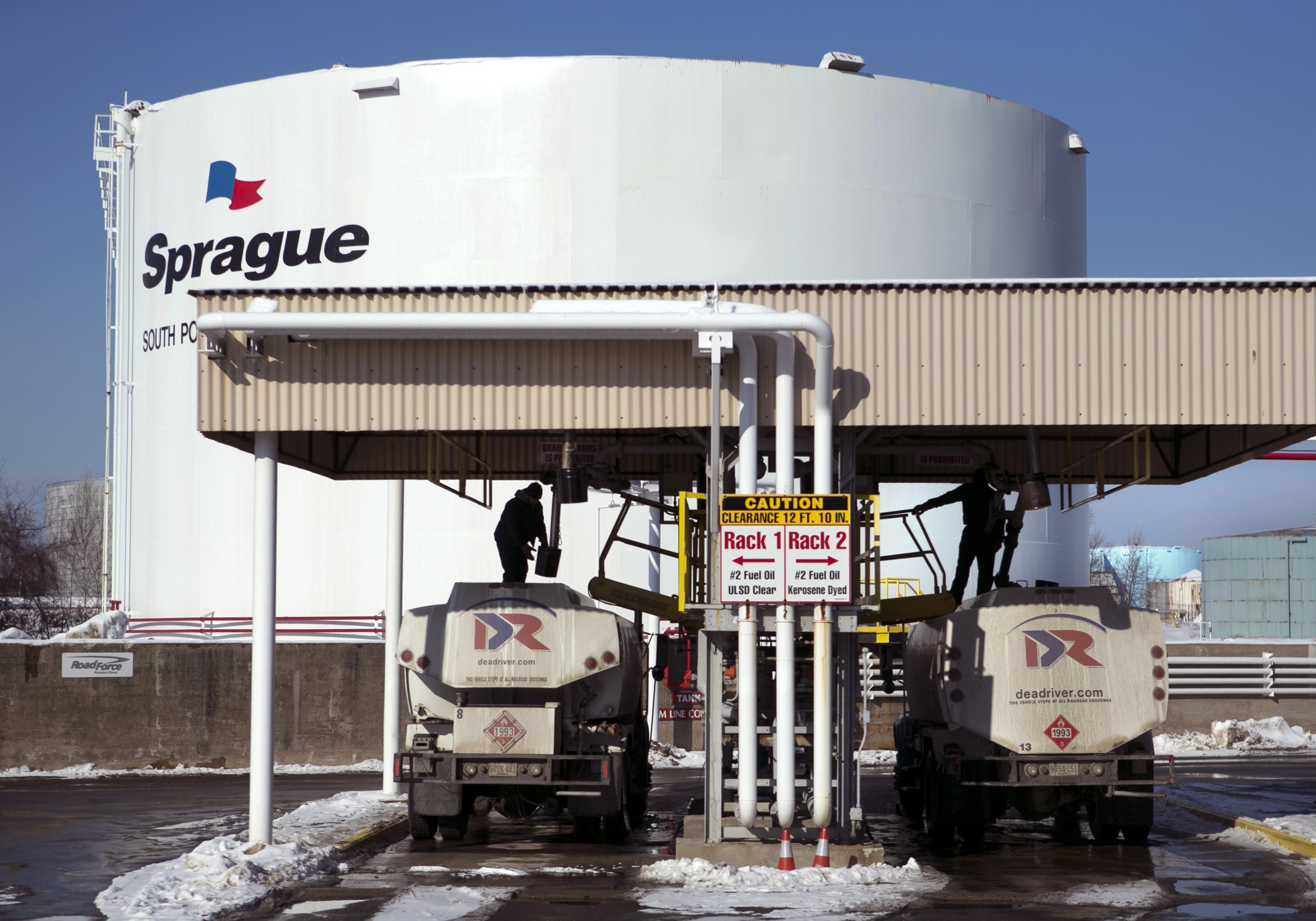 Drivers for an oil delivery company fill their trucks at the Sprague terminal, on Jan. 16, 2014, in South Portland, Maine. Diesel and heating oil supplies in the Northeast are more than 50% below the recent average, raising concerns that an extreme weather event could cause supply disruptions, federal officials said. 