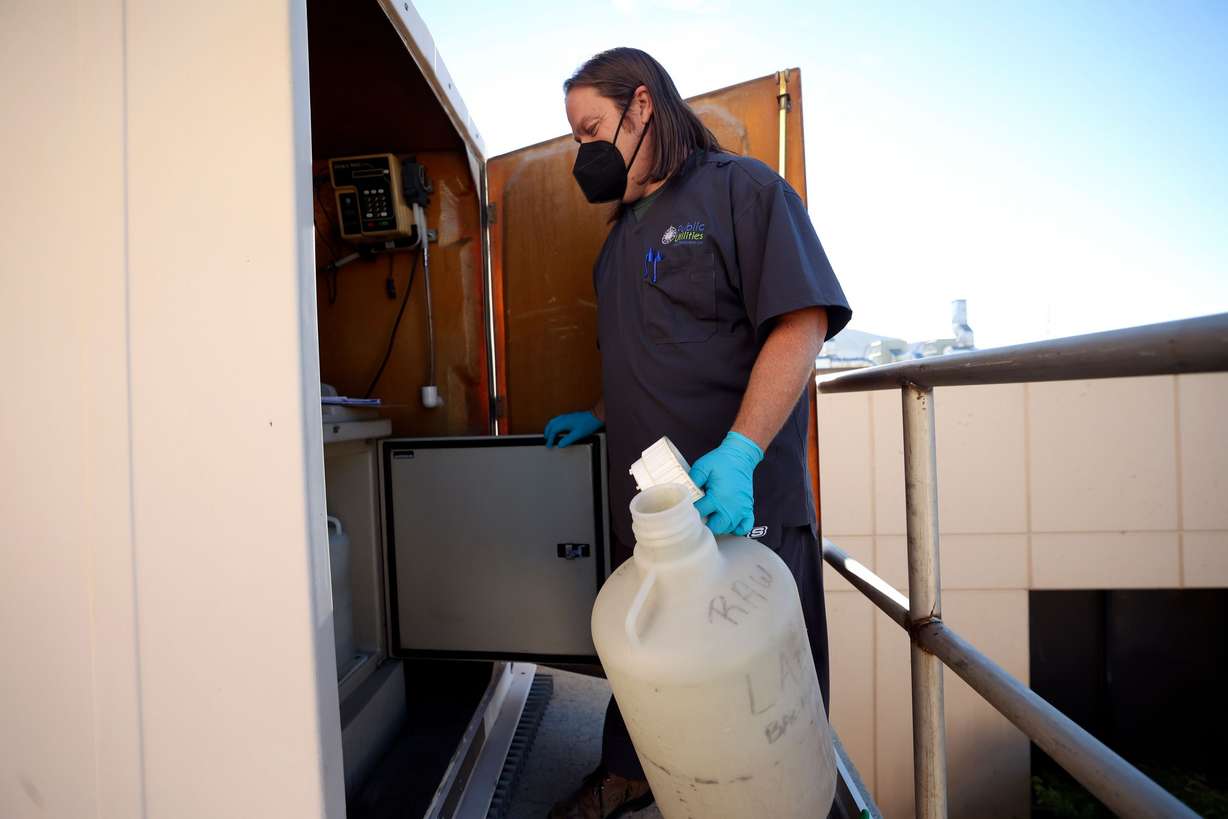 Jonathan Yonk, Salt Lake City Water Reclamation Facility senior chemist, collects a 24-hour composite sample of wastewater at the Salt Lake City Water Reclamation Facility in Salt Lake City on Aug. 16.